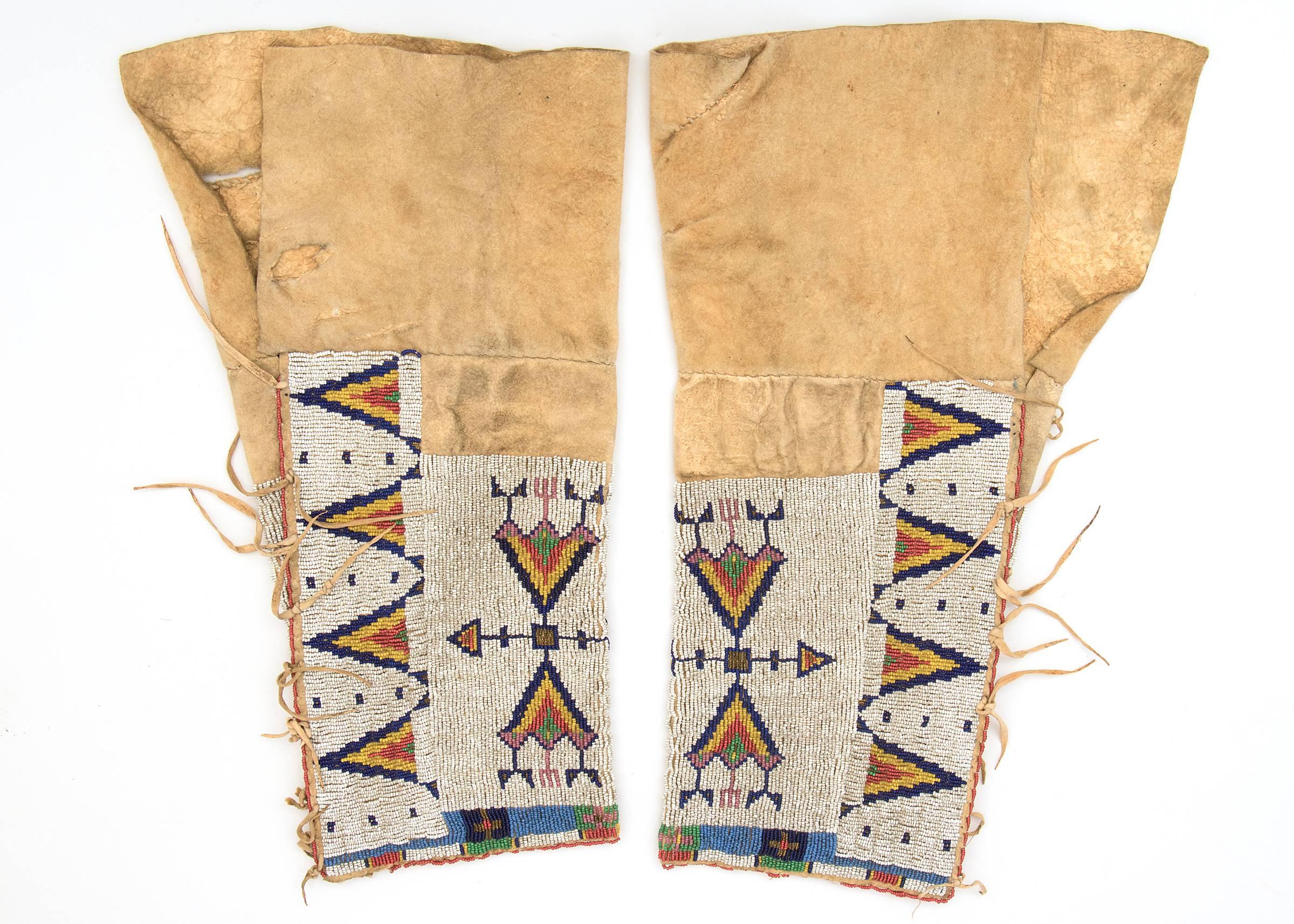 A pair of leggings constructed of native tanned hide decorated with trade beads. Design elements include stylized arrow and tepee/tipi motifs.

A Nomadic tribe, the Sioux are associated with areas of the great plains of the United States including