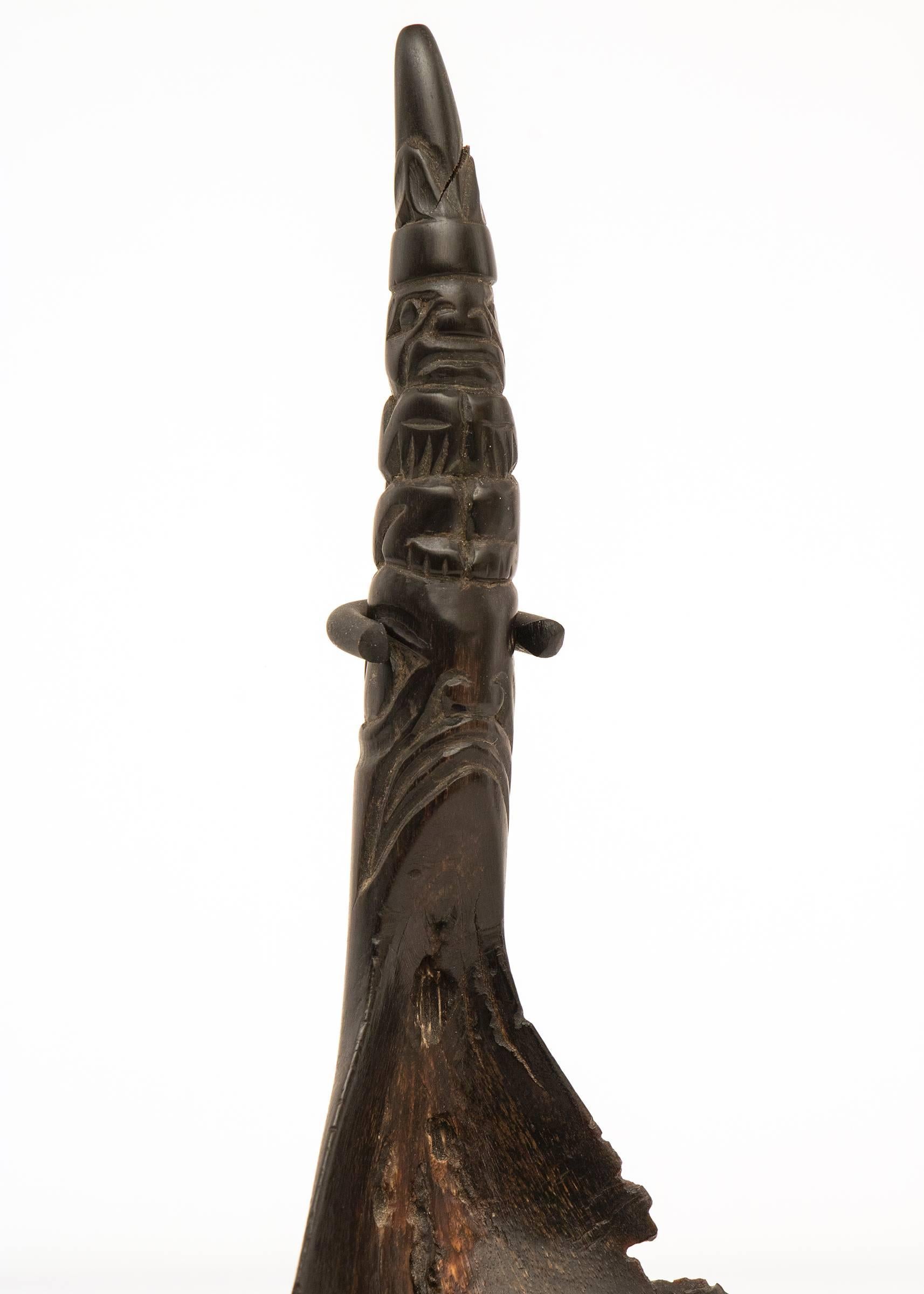 An American Indian/Northwest coast spoon or ladle exquisitely carved with animal effigies. Custom display stand is included. Overall dimensions with the stand are 7.25 x 1.5 x 2.25 inches; spoon measures 6 x 2.25 x 3.5 inches.

Carved horn spoons