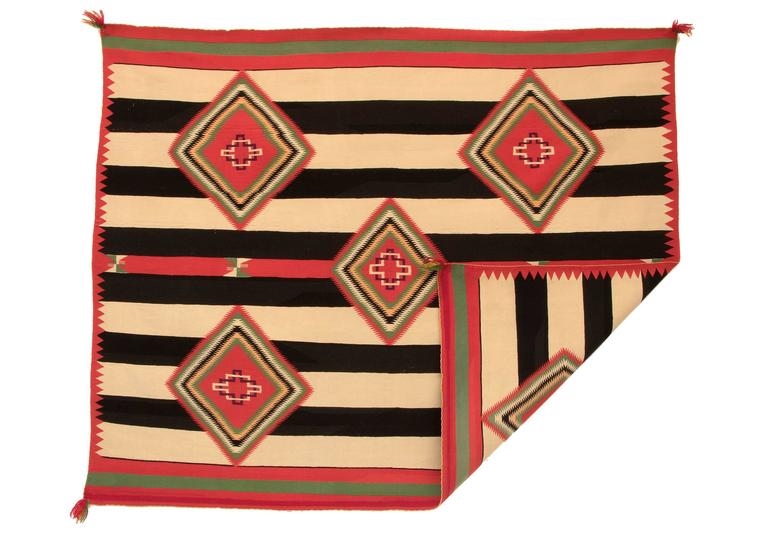 Vintage 19th century, circa 1890 Navajo Chiefs blanket with a unique design, a variant of a third phase pattern with five diamonds against a classic banded ground. Expertly woven of Germantown wool in shades of green golden yellow, and red with