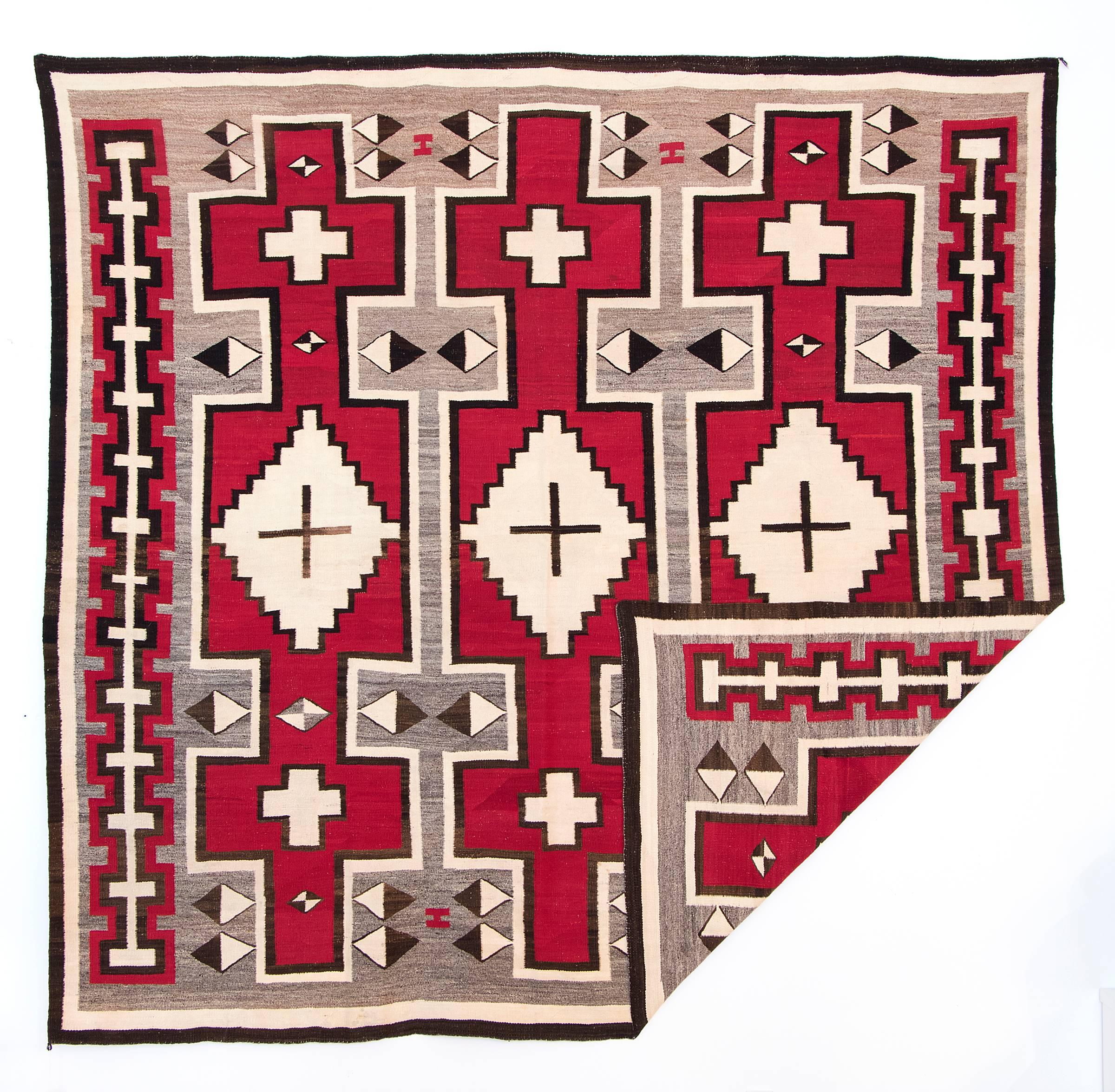 An exceptional early Trading Post era rug with pictorial elements including crosses and diamond motifs. Expertly woven by a Native American (Navajo) weaver for the Ganado Trading Post (founded by John Lorenzo Hubbell at Ganado, Arizona, in 1876).