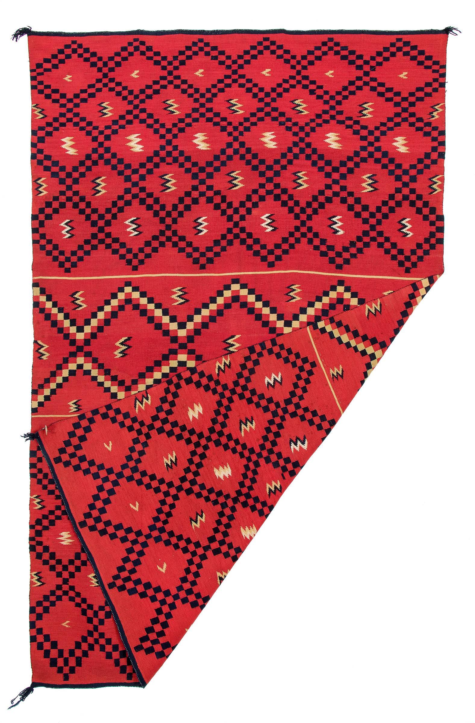 A Classic period (pre-reservation) Navajo sarape/blanket. Finely woven of native hand-spun wool with indigo (blue), rabbit brush (soft yellow) and cochineal (red) dye.

Provenance: 
Fred Harvey Company 
Herbert G. Wellington, New York
By