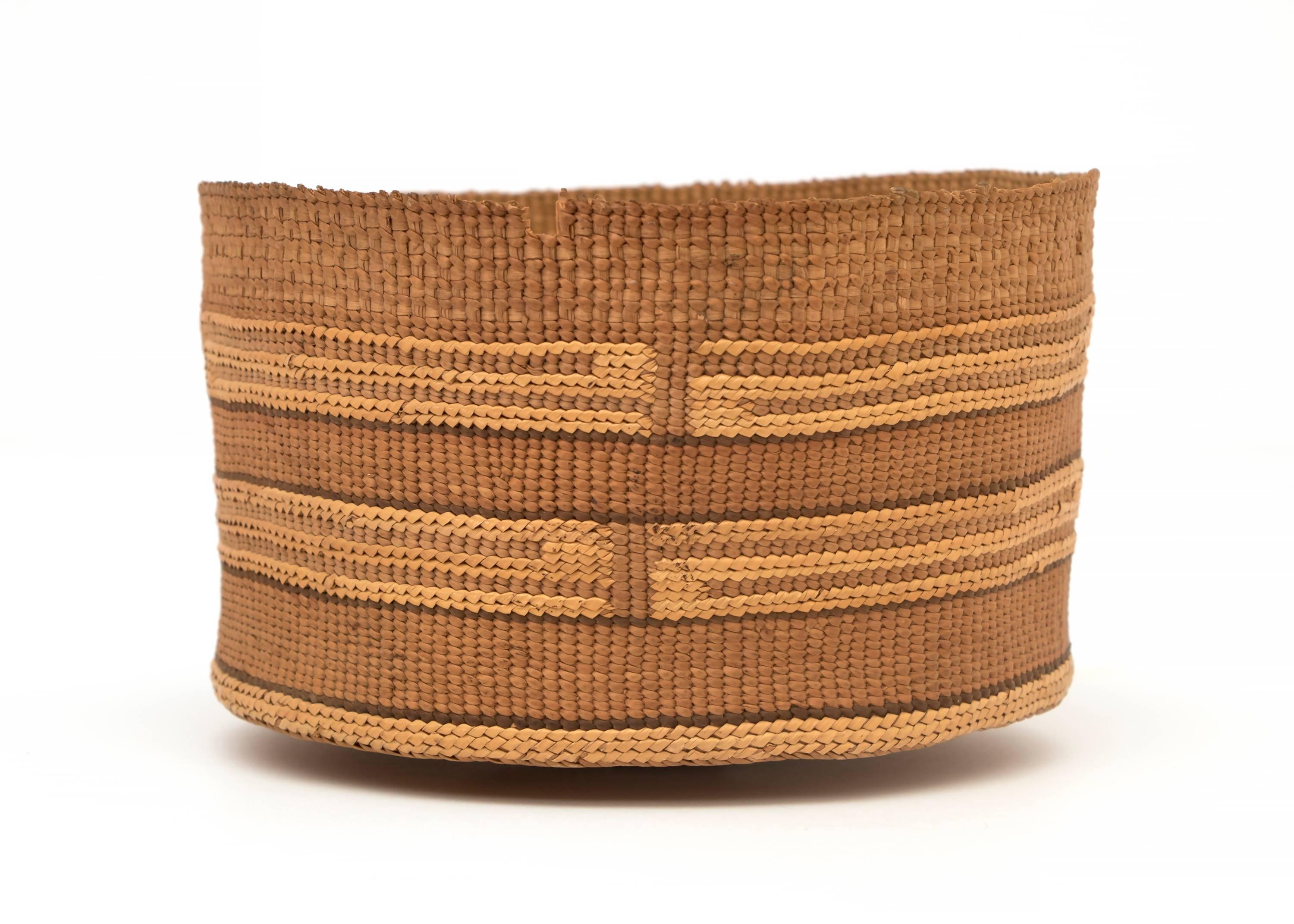 A tightly woven Pacific Northwest coast gathering basket. 
 
The Tlingit peoples are indigenous to the Pacific Northwest Coast; inhabiting southeastern Alaska, portions of British Columbia and the Yukon in Canada.