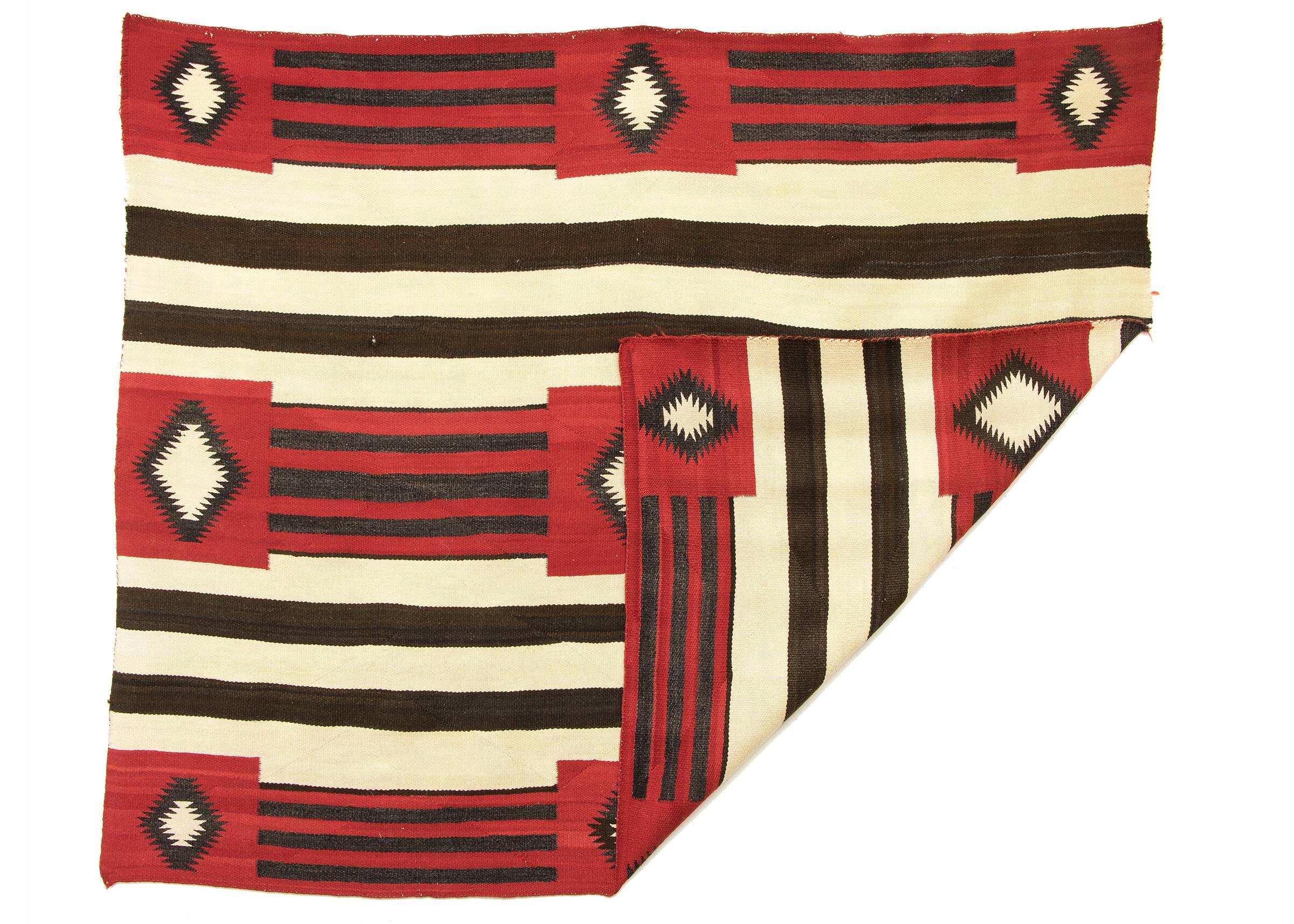 This rug is a revival of a Chief's wearing blanket in a third phase variant (or fourth phase) pattern with a nine-point pattern against a Classic banded ground.

Woven of native hand-spun wool in natural fleece colors of ivory and brown/black with