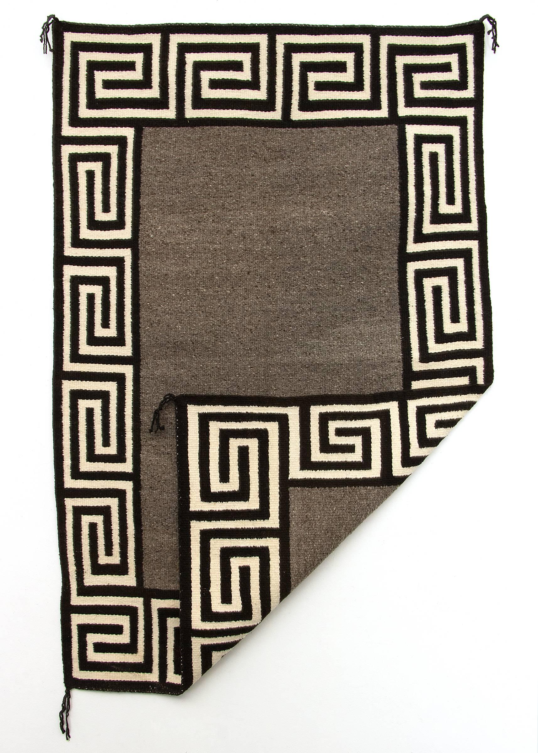 Native hand-spun wool in natural fleece colors of grey, ivory and black.

This piece is well suited for use on the floor as an area rug or as a wall hanging.