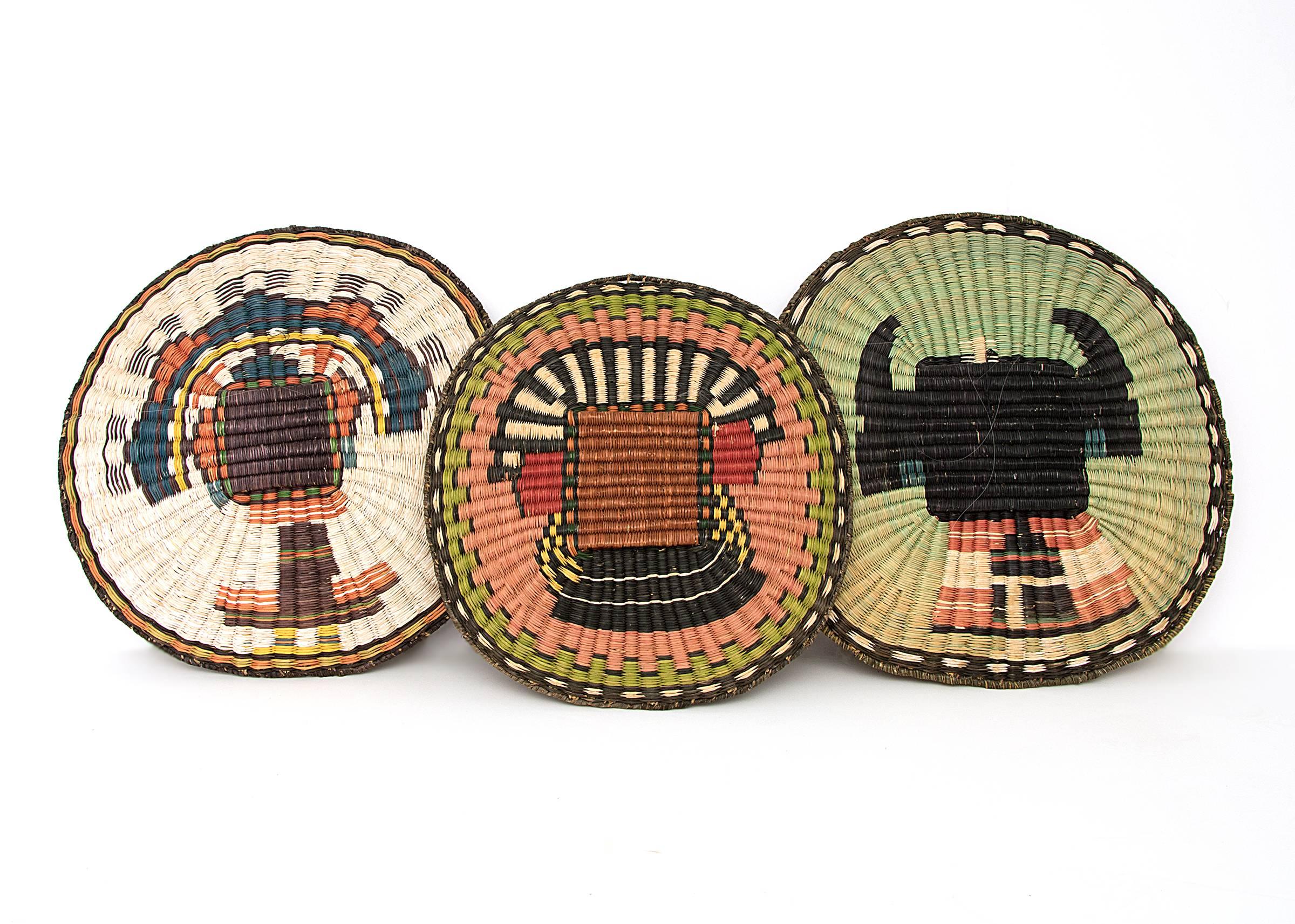 Originating at the Hopi Third Mesa, these trays are woven of sumac with images of Kachinas. Plaques such as these play an integral role in Hopi wedding ceremonies and various life cycle events and are often woven as gifts. 

Individual