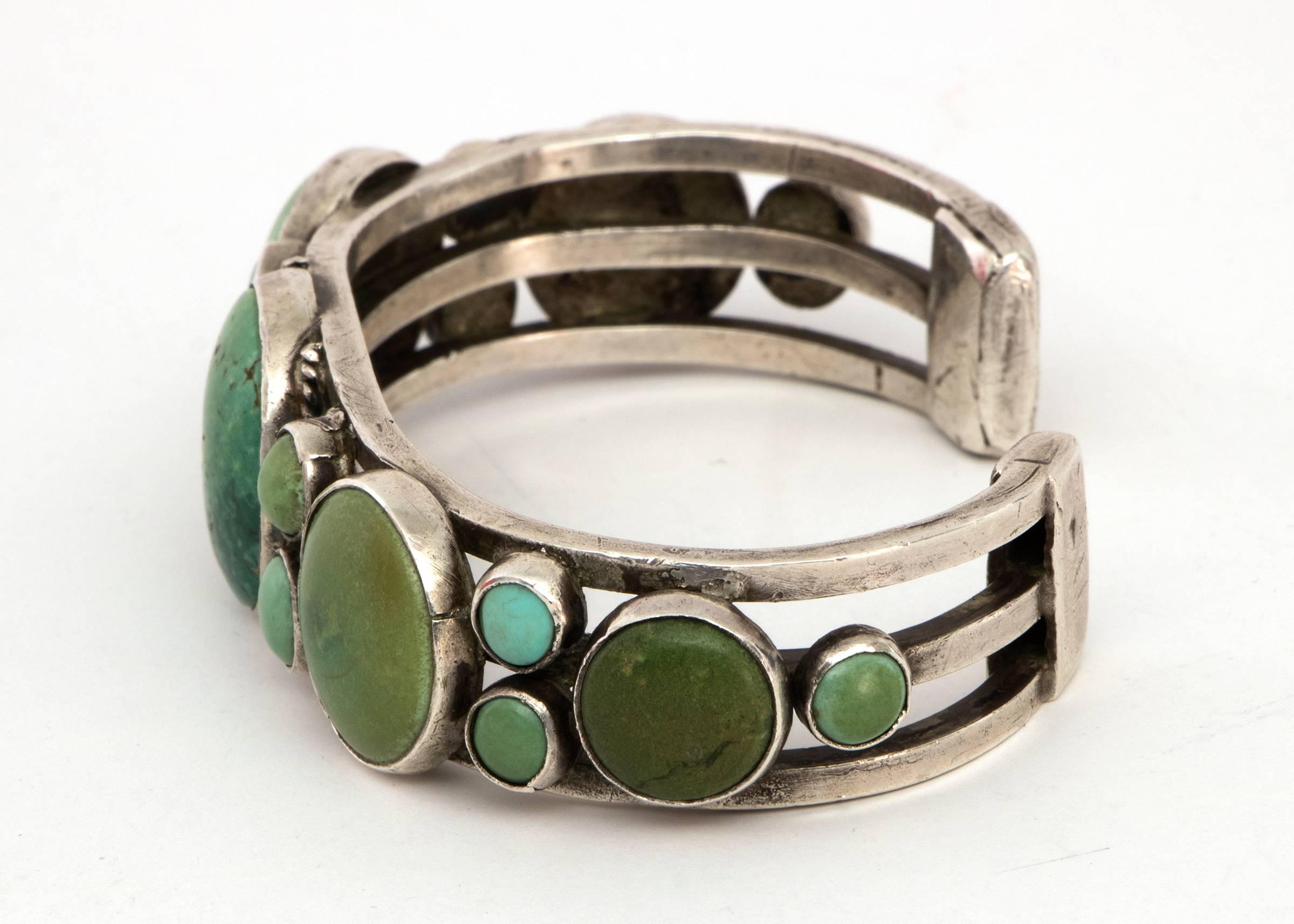 Vintage Navajo Old Pawn bracelet created with silver and large green Cerillos Turquoise, circa 1940.  The interior circumference of the bracelet measures 6 ⅝ (5 ½