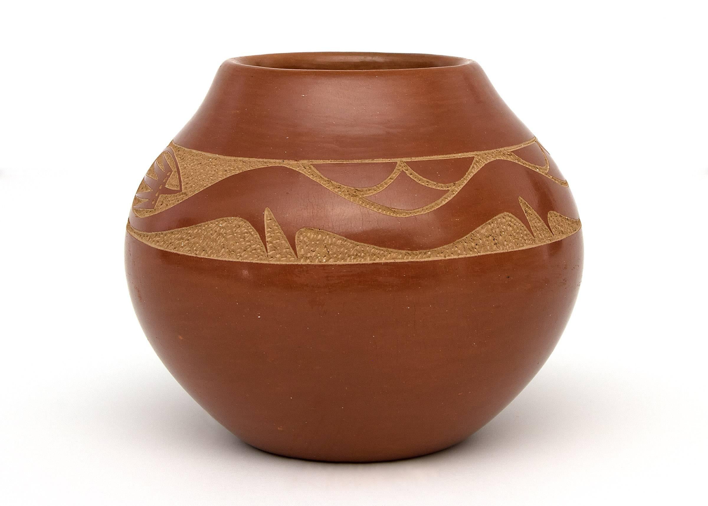 A redware olla with a sgraffito/incised Avanyu water serpent by San Ildefonso potter, Tony Da, Thun-Phoe-She (Sun Dew). Earthenware with slip glazes, signed on base by the artist.

Olla is in very good condition - please contact us for a detailed