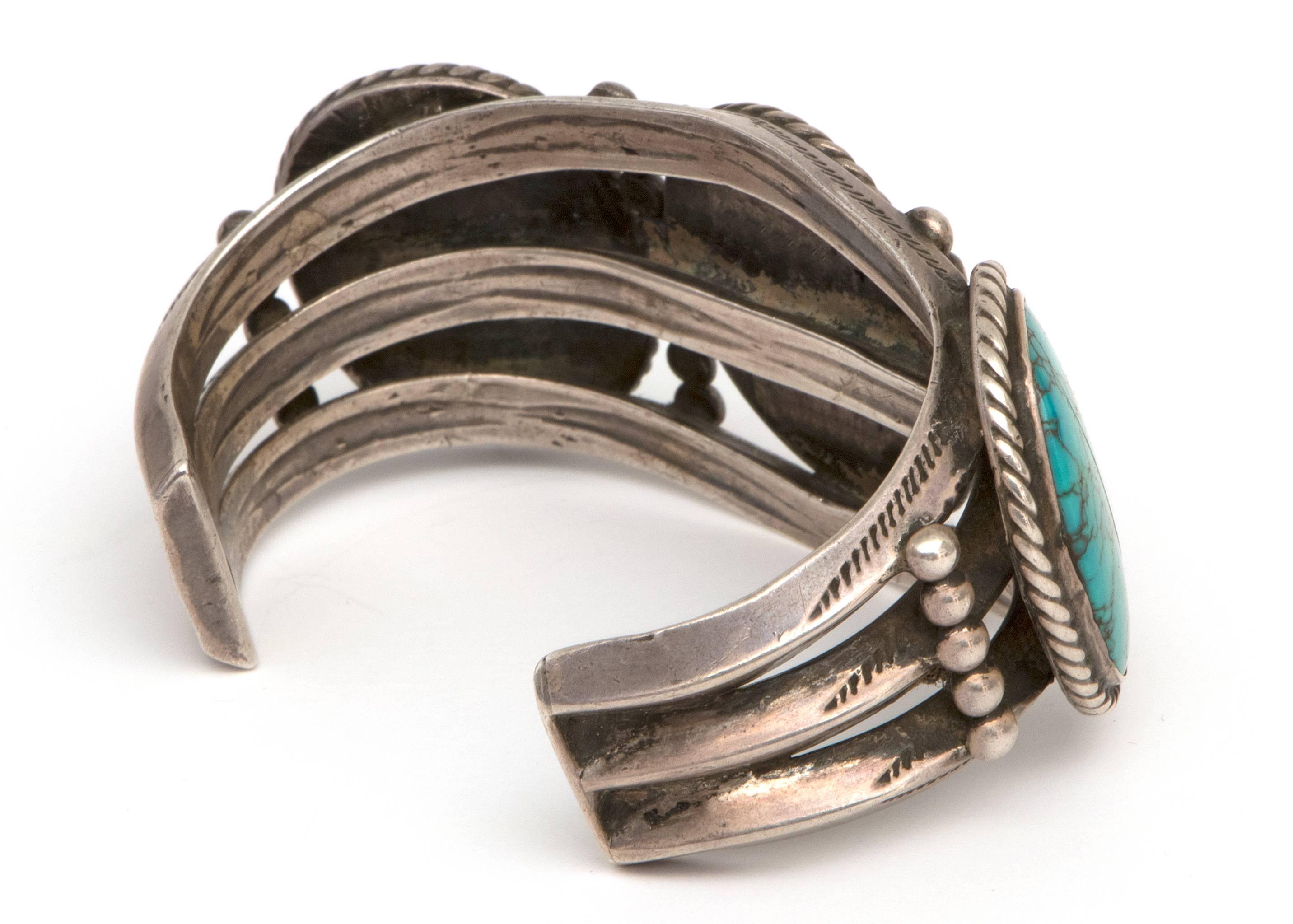 A vintage trading post era/old Pawn Navajo (Native American Indian) Southwestern silver cuff bracelet with three oval turquoise stones.  The bracelet has been minimally polished to preserve the patina and can be polished to a bright silver.