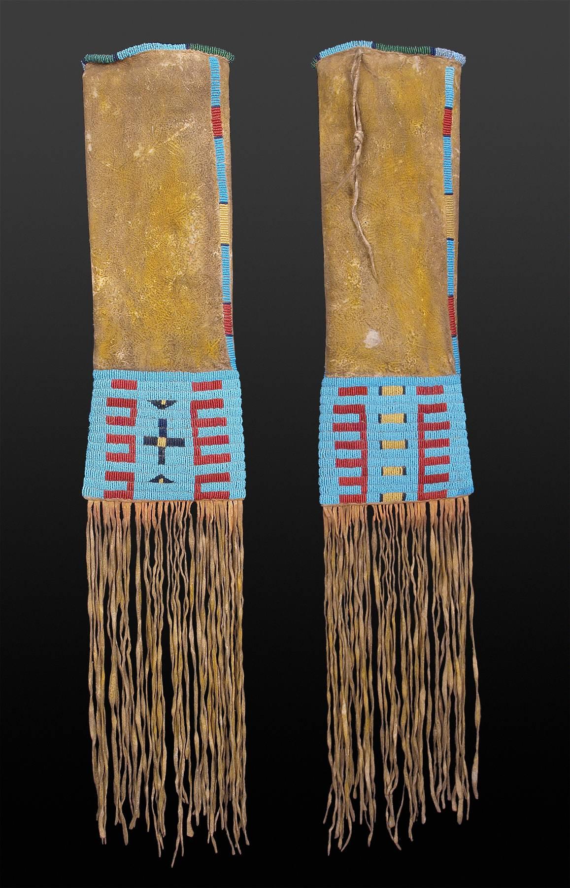 Classic period Sioux (North American Indian) pipe bag/tobacco bag dates to circa 1850-1875. It is constructed of native tanned hide, sinew-sewn and beaded in traditional Sioux colors and design and rubbed with yellow ochre pigment. Custom wall mount