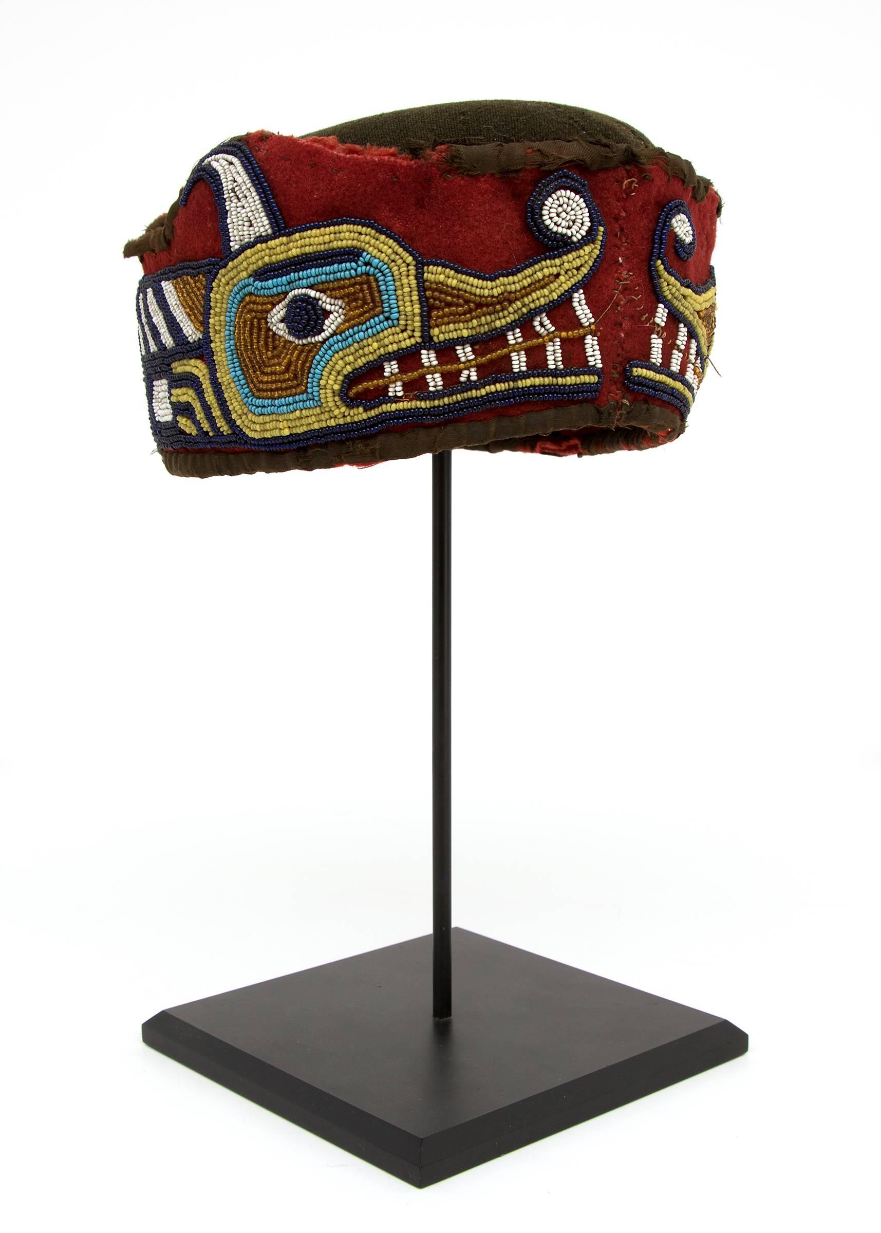 Antique Native American Northwest Coast Beaded Head Ring with a Sisiutl Design, Kwakwaka'wakw (Kwakiutl), circa 1890, constructed of Trade cloth and glass beads.
Measurements listed include the custom tabletop display stand. The hat alone measures