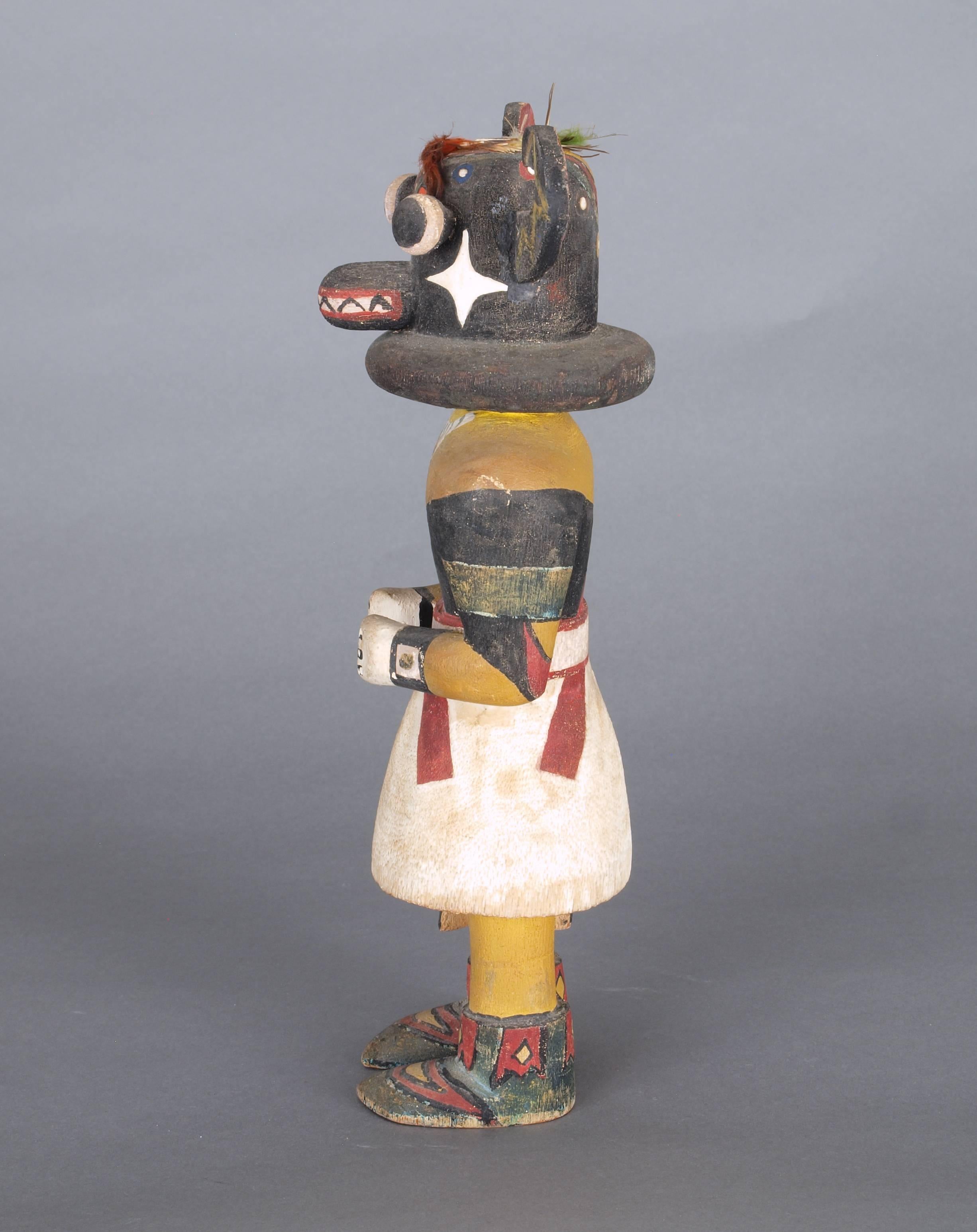 A pair of kachina/katsina dolls. As shown together, overall measurements are 12 inches, height x 10 inches, width x 3.25 inches, depth.

Left: Ho'ote - admired for his beautiful songs, this kachina represents a prayer for the flowers of flowers of