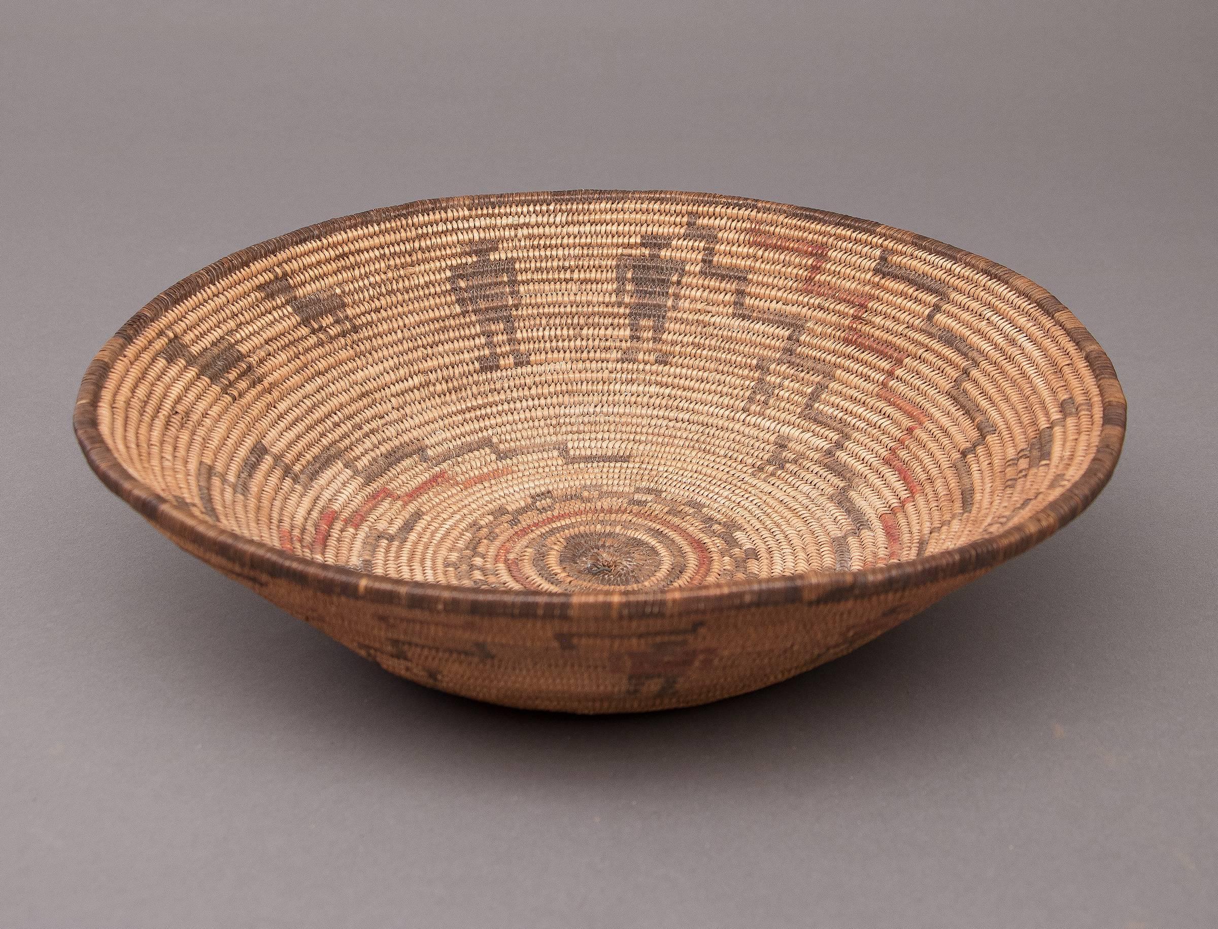 A native American basket in a bowl/tray form woven by an Apache, circa 1890. The polychrome design includes human figures, and horses/dogs.

As with all our offerings, authenticity is fully guaranteed.

Expedited and International Shipping is
