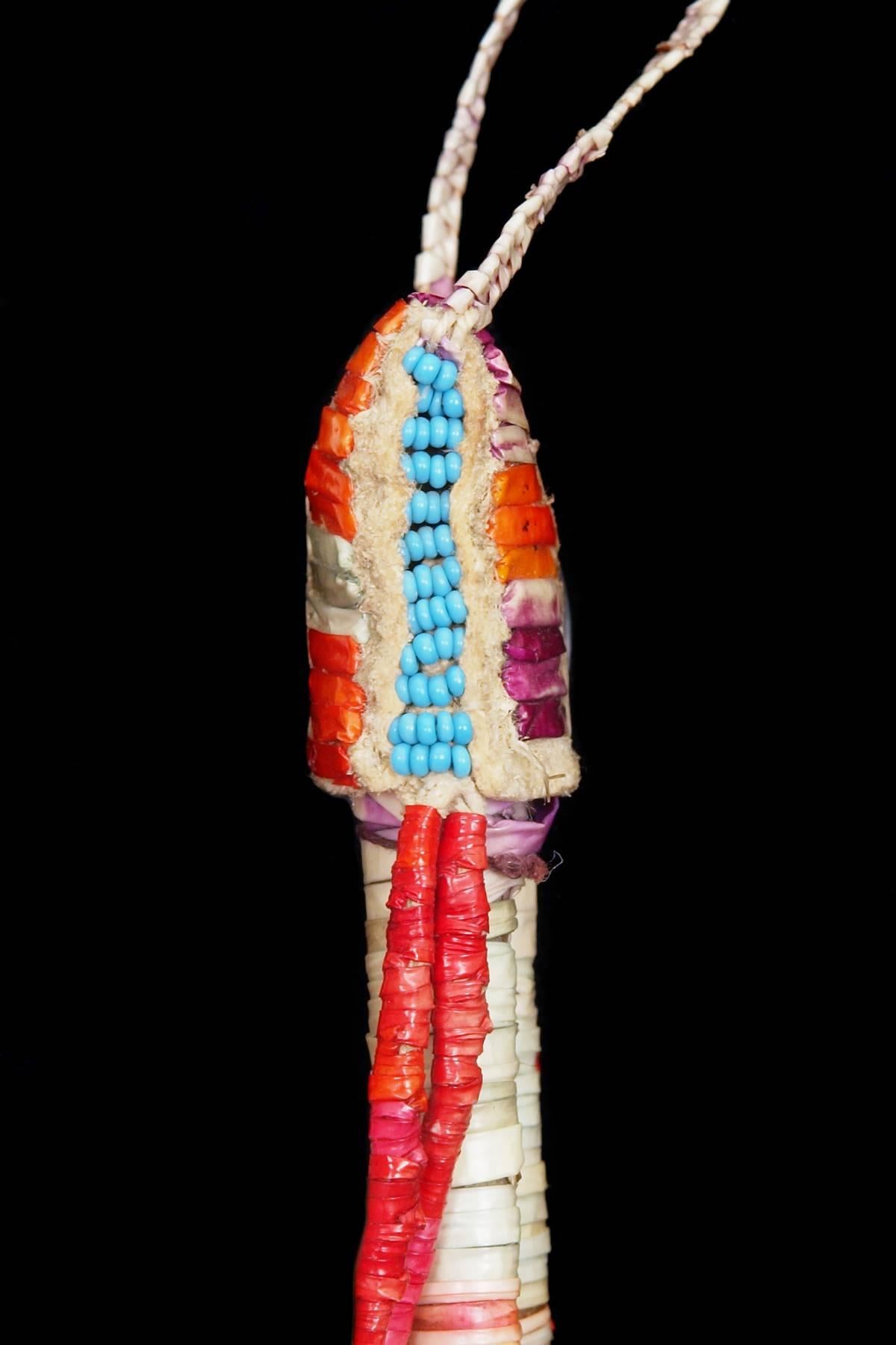 An exquisite antique Native American Awl Case created by a Sioux (Plains Indian), hide is intricately wrapped in quills that were dyed in multiple colors including red, orange, yellow, purple, blue and white, the suspensions are adorned with