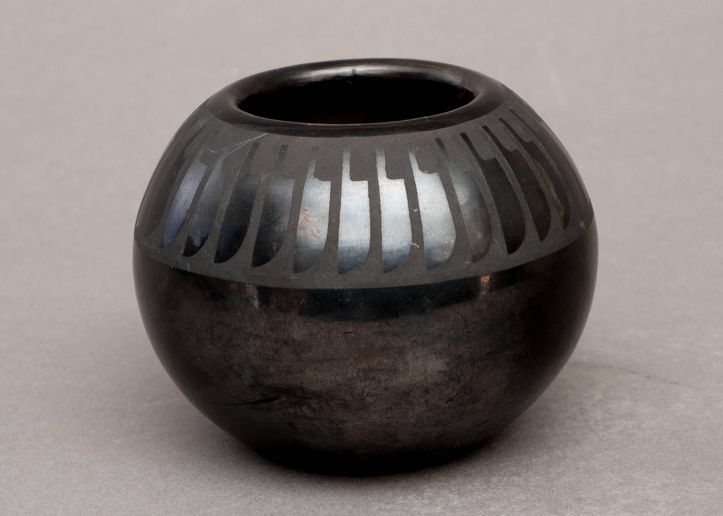 A bowl or seed jar with Maria's classic feather motif around the shoulder.  Gunmetal finish.  signed 