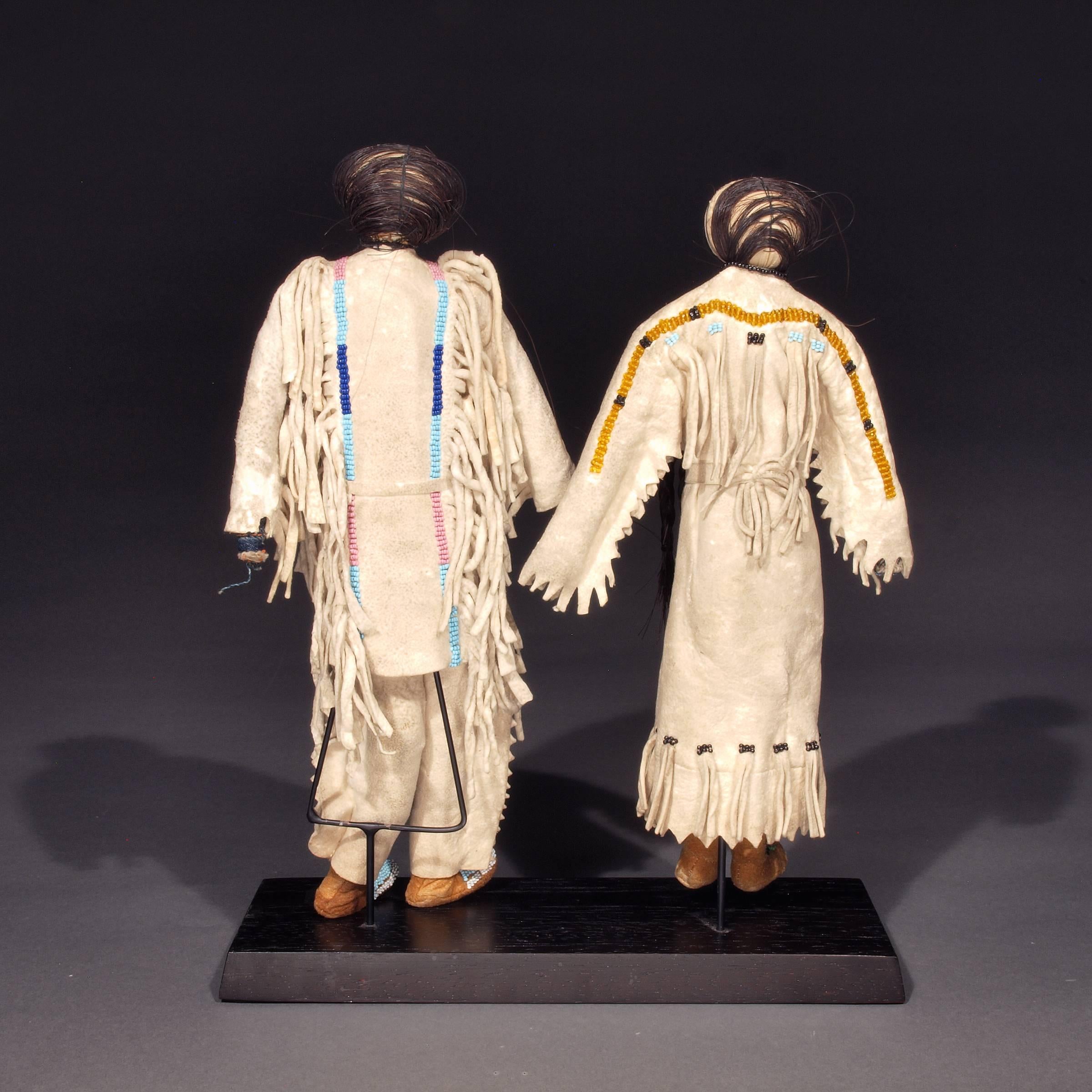 A rare pair of American Indian dolls. Constructed of native tanned hide, sewn with sinew and adorned with decorative glass trade beads and horse hair. A nomadic tribe, the Sioux are associated with areas of the Great Plains of the United States