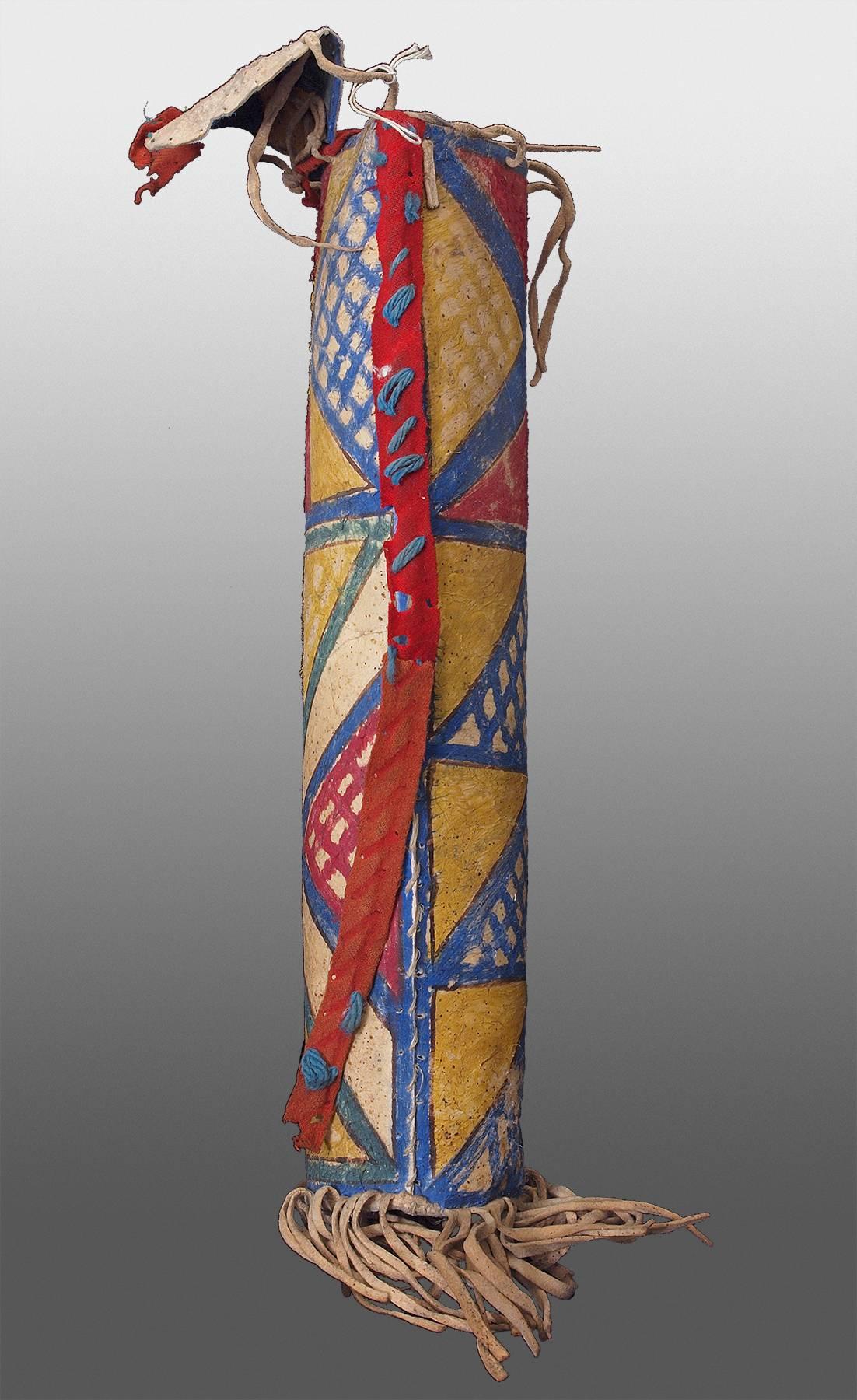 Constructed of rawhide and painted with natural pigments with native tanned hide fringe.  Cylinder forms such as this were originally created exclusively for sacred objects such as rolled feather headdresses, ceremonial clothing, feathers and