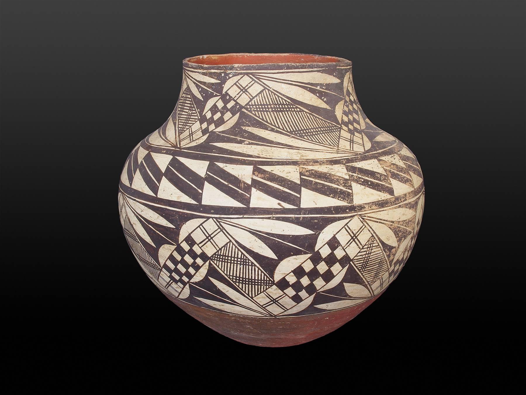 A graceful jar form built by hand from native clay by an American Indian potter at Acoma Pueblo and very finely painted with slip glazes.

Acoma Pueblo is located in New Mexico approximately 60 miles west of Albuquerque. Jars or Ollas such as this