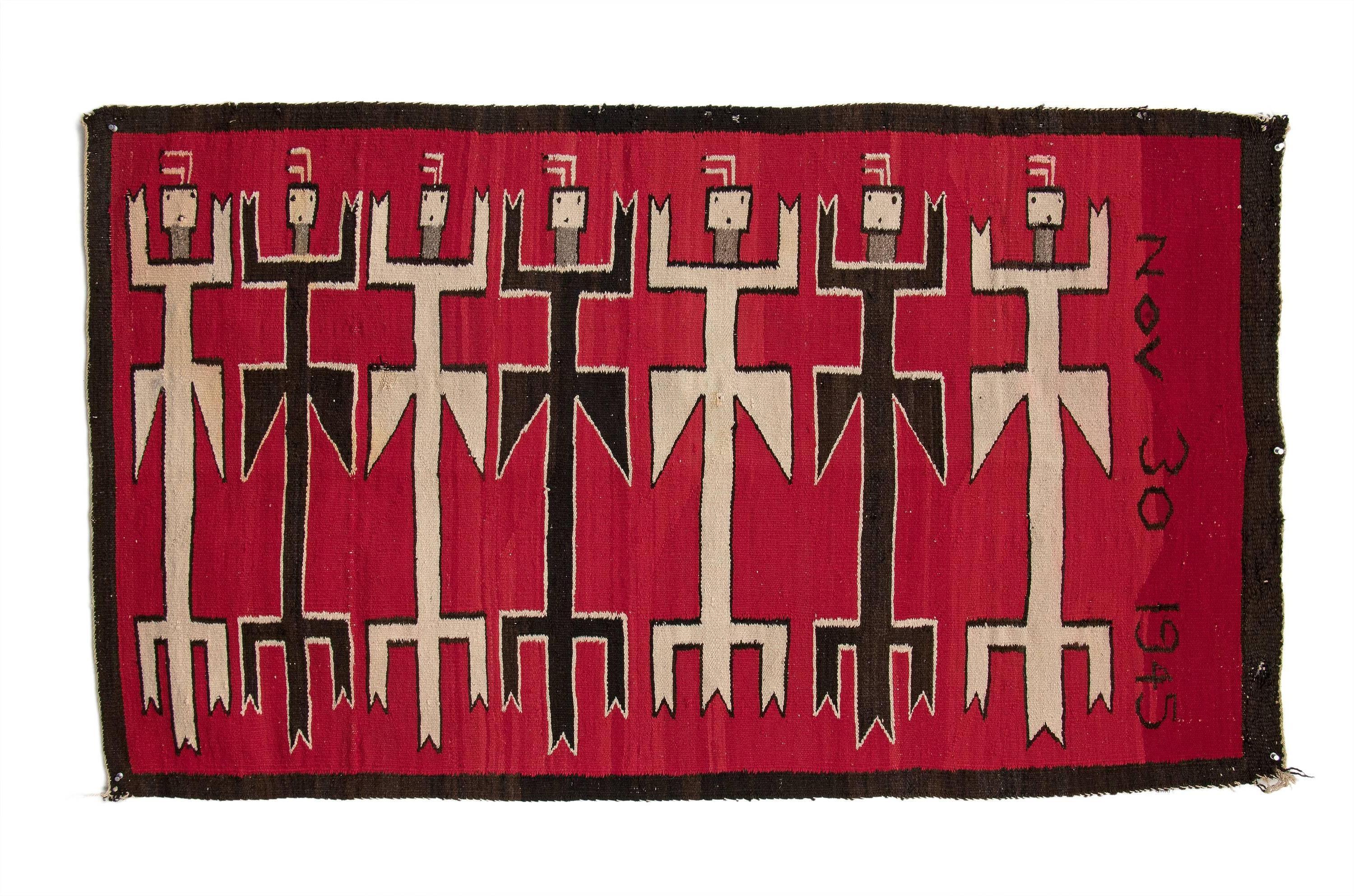 Vintage 1940s Navajo Yei (Yeibichai) area rug depicting eight pollinator figures as well as the date 