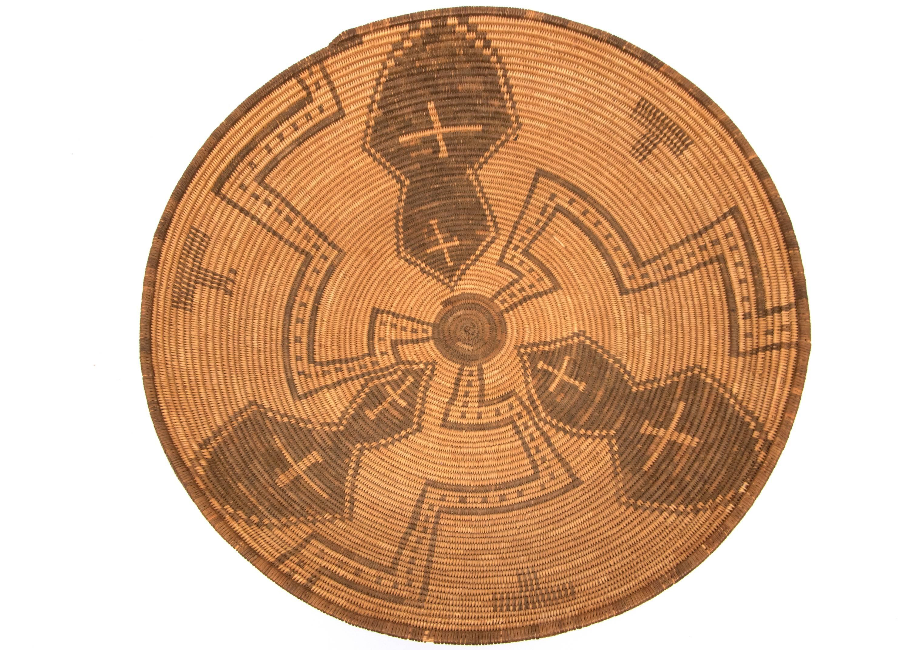 Vintage 19th century, circa 1890, Pictorial Apache (North American Indian) basket in a rounded bowl/tray  form masterfully woven of willow and devil's claw with cross and meandering pinwheel elements.  The Apache, a nomadic American Plains Indian