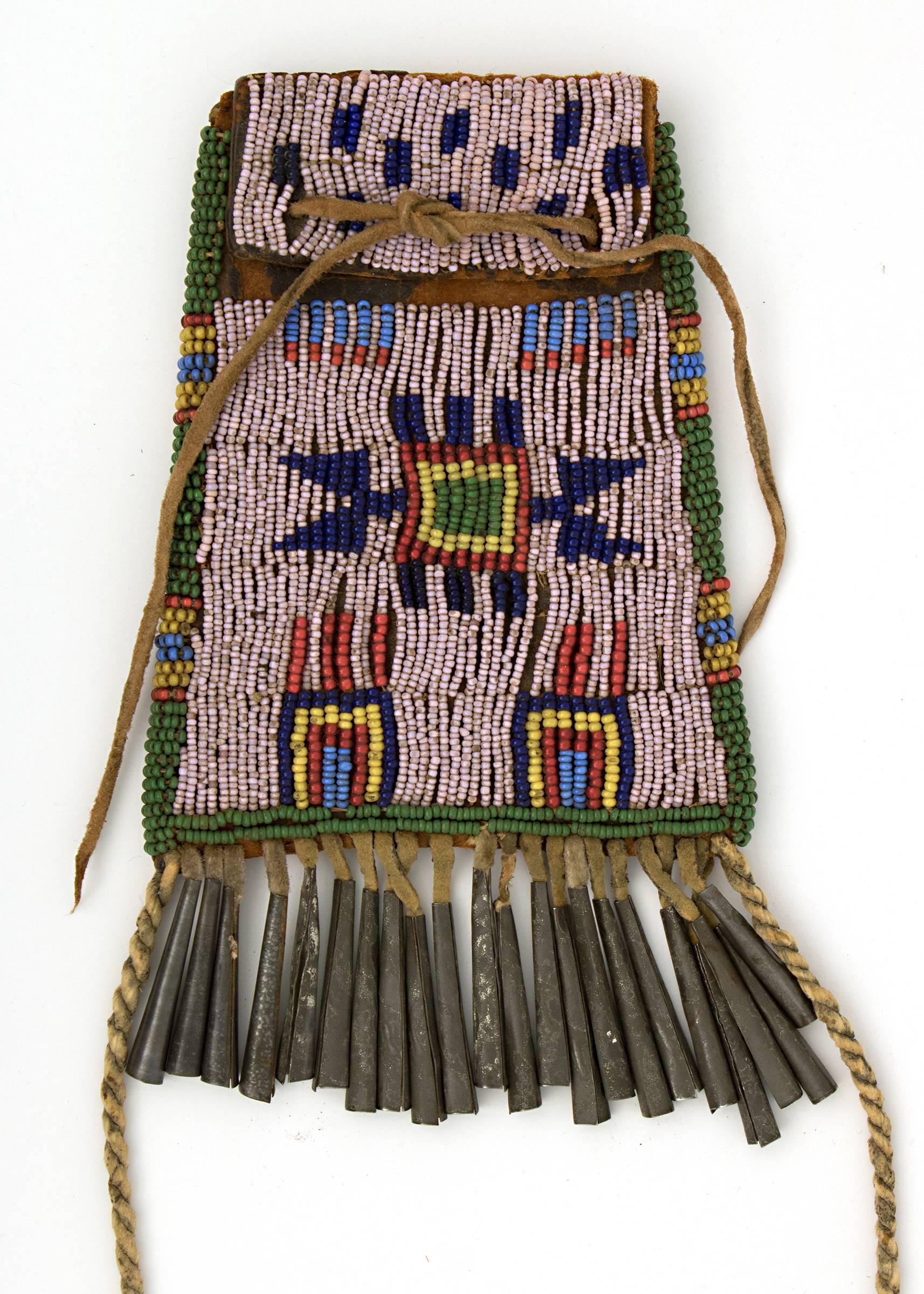 Northern Arapaho Strike-A-Lite bag. Constructed of commercial harness leather with trade beads and tin cones.

The Arapaho, members of the Plains Indian culture group, were nomadic with territory extending across parts of present day Colorado,