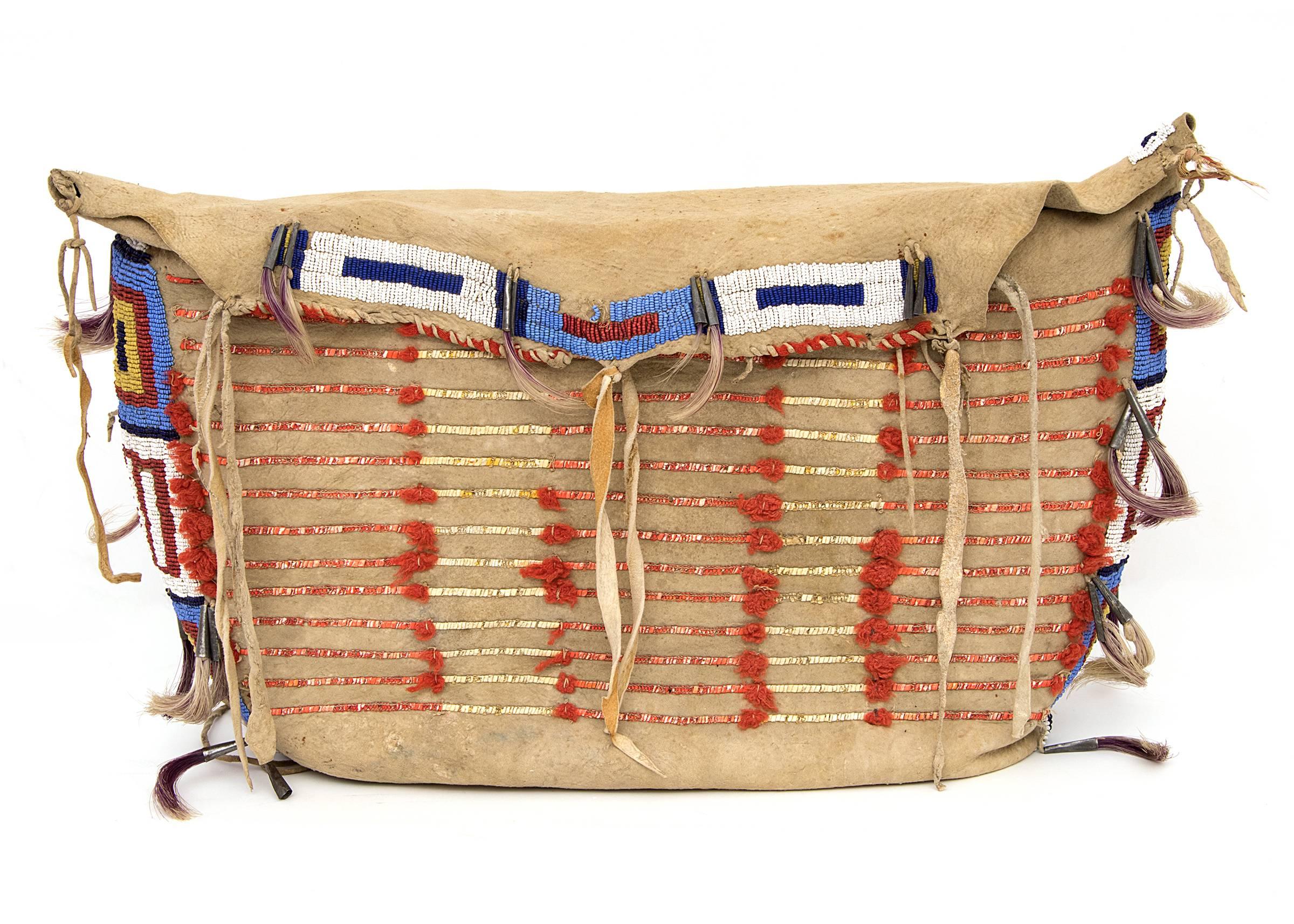 Also referred to as a Tepee (Tipi) bag, this piece is constructed of native tanned hide with trade beads, quill work, trade cloth, tin cones and horse hair.

Part of the Plains Indian culture group, the Sioux territory included parts of present-day