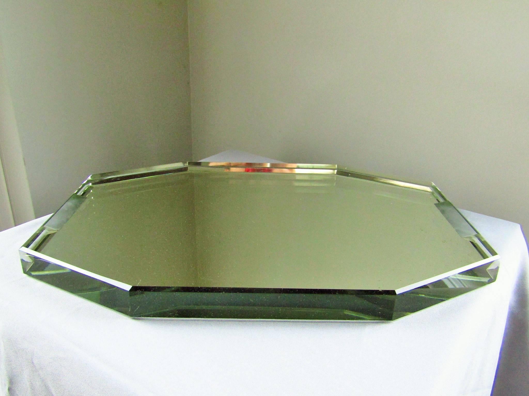 Extraordinary octagonal Art Deco glass tray by Jean Luce, France, 1930. Backside mirrored. Cut handles. Two micro lesions, only some small blind spots (see picture). Very heavy! 

Measures: Length 44cm (17.4 in),
width 31cm (12.2 in),
thickness