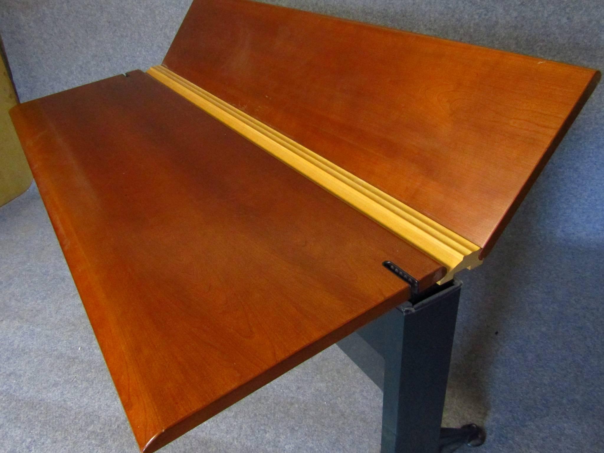 Adjustable desk by Geoff Hollington for Herman Miller (signed).

This high performance adjustable desk can function as a stand up or seated work surface. The table desk has a back surface that tilts up for display or lays flat for an enlarged work