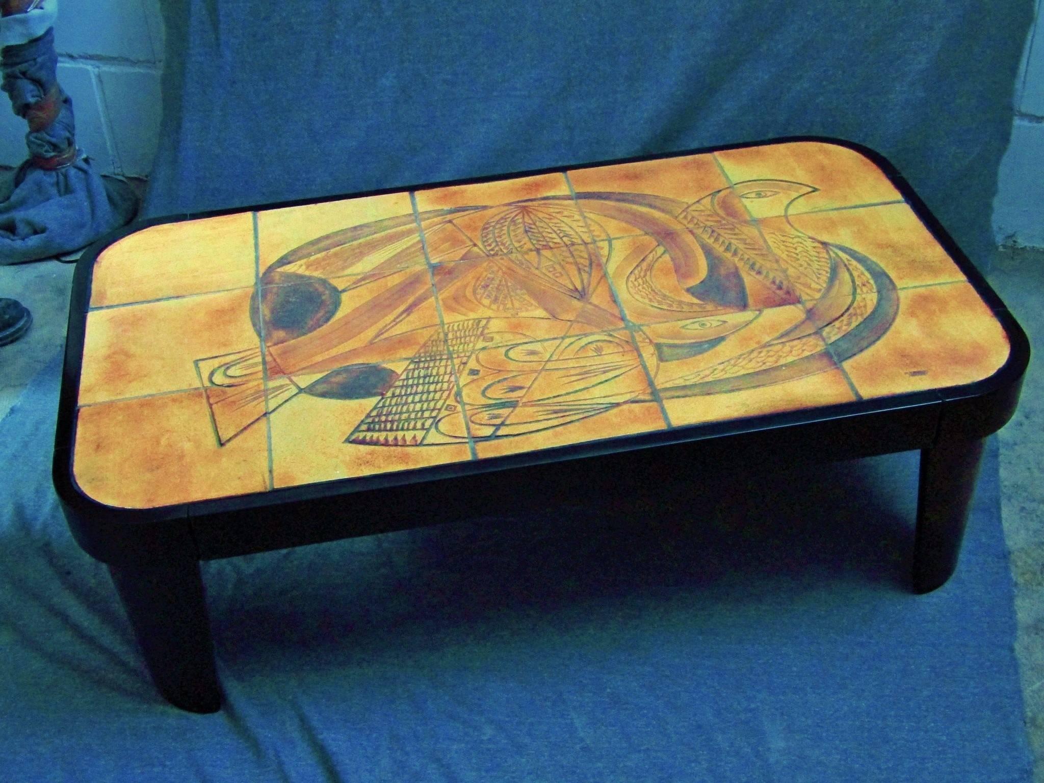 1960s coffee table signed by Raymonde Leduc with wooden base and top surface composed of stoneware tiles with handmade Kinetic cubist decor. Multi-color.

Manufactured in Vallauris, France.

 