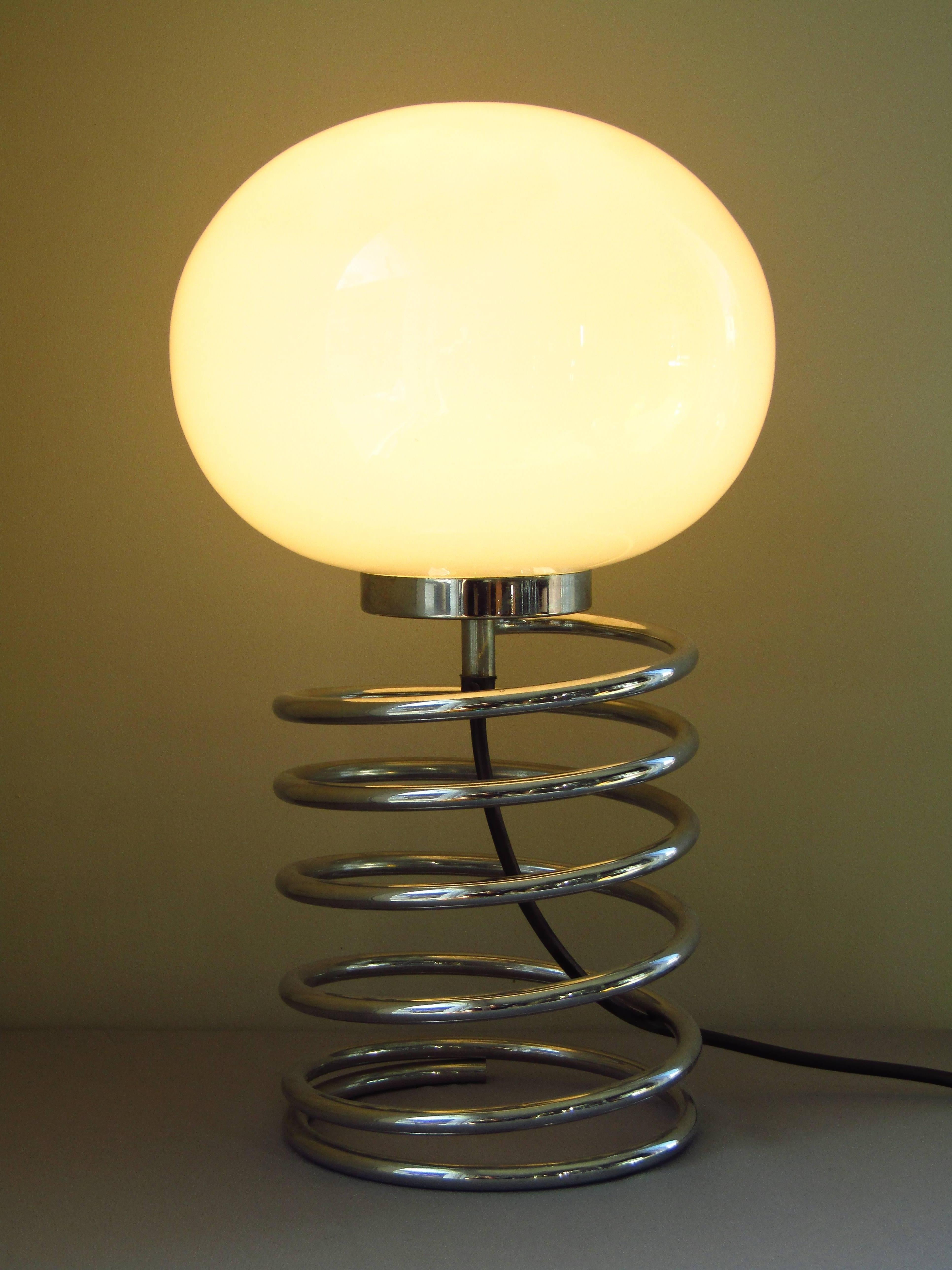 Table lamp Spirale, designed circa 1965 by Ingo Maurer for Design M. was built in two different sizes, this is the large. Have a look for the small one also available in my shop.
Chrome metal base, opaline glass shade.

 