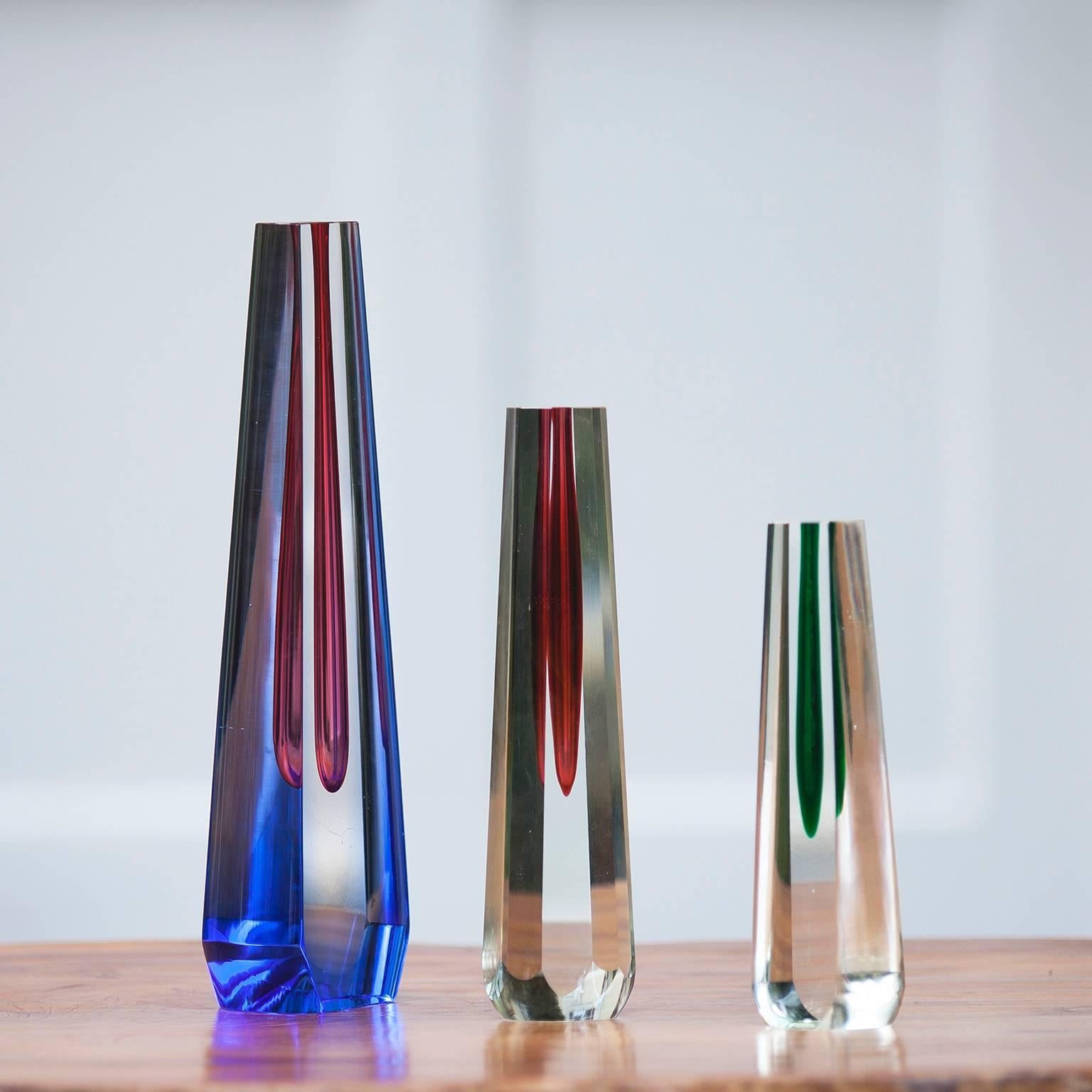 Set of three sculptural glass vases by Pavel Hlava, Czech, 1960. A deep blue, red and green teardrop is suspended in a clear glass form. The inner tubular core can be used as a vase, but this is more of a sculpture.

Measures: Blue 31 x 9 x 5.2