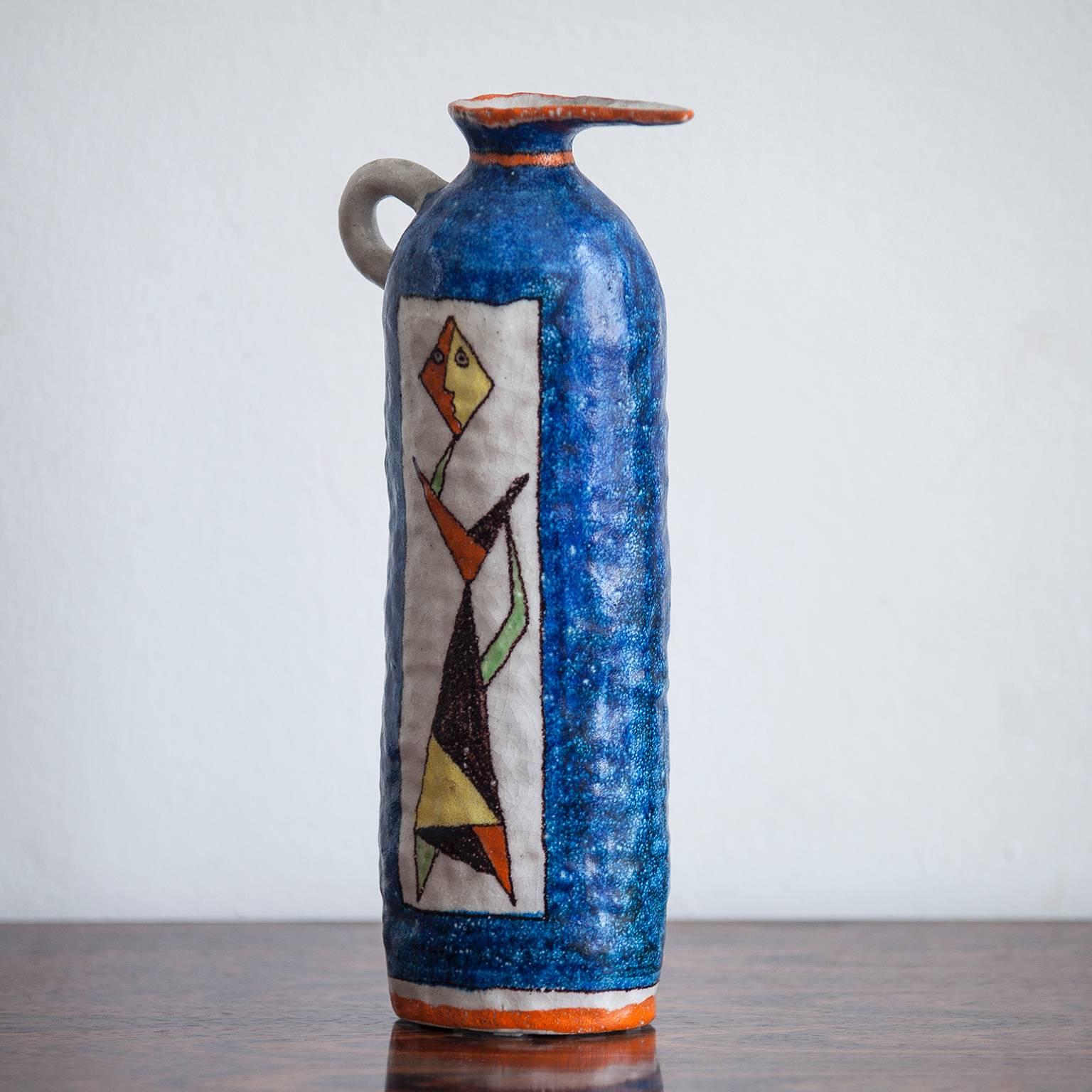 Very impressive blue pitcher by Andrea D'Arienzo, Italy, 1950. Geometric underglaze painting in yellow, orange-red, black on white textured background. Andrea D'Arienzo worked with Guido Gambone in his studio in the 1960 decade.
           