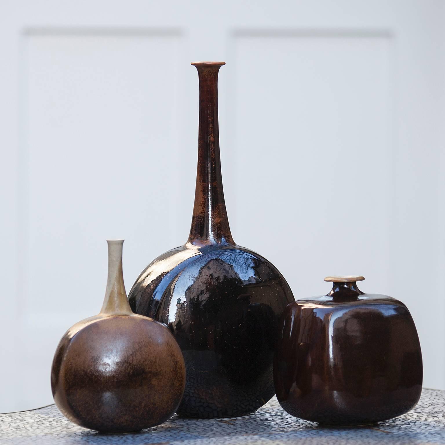 Beautiful set of three art pottery vases in brown glazed ceramic from 1970s by Gerald and Gotlind Weigel, Germany.
Measures: H 44 x W 23 x 14 cm H 18 x D 19 cm H 23 x D 17 cm.
Gerald Weigel, born in 1925, grew up in Thuringen where, like his