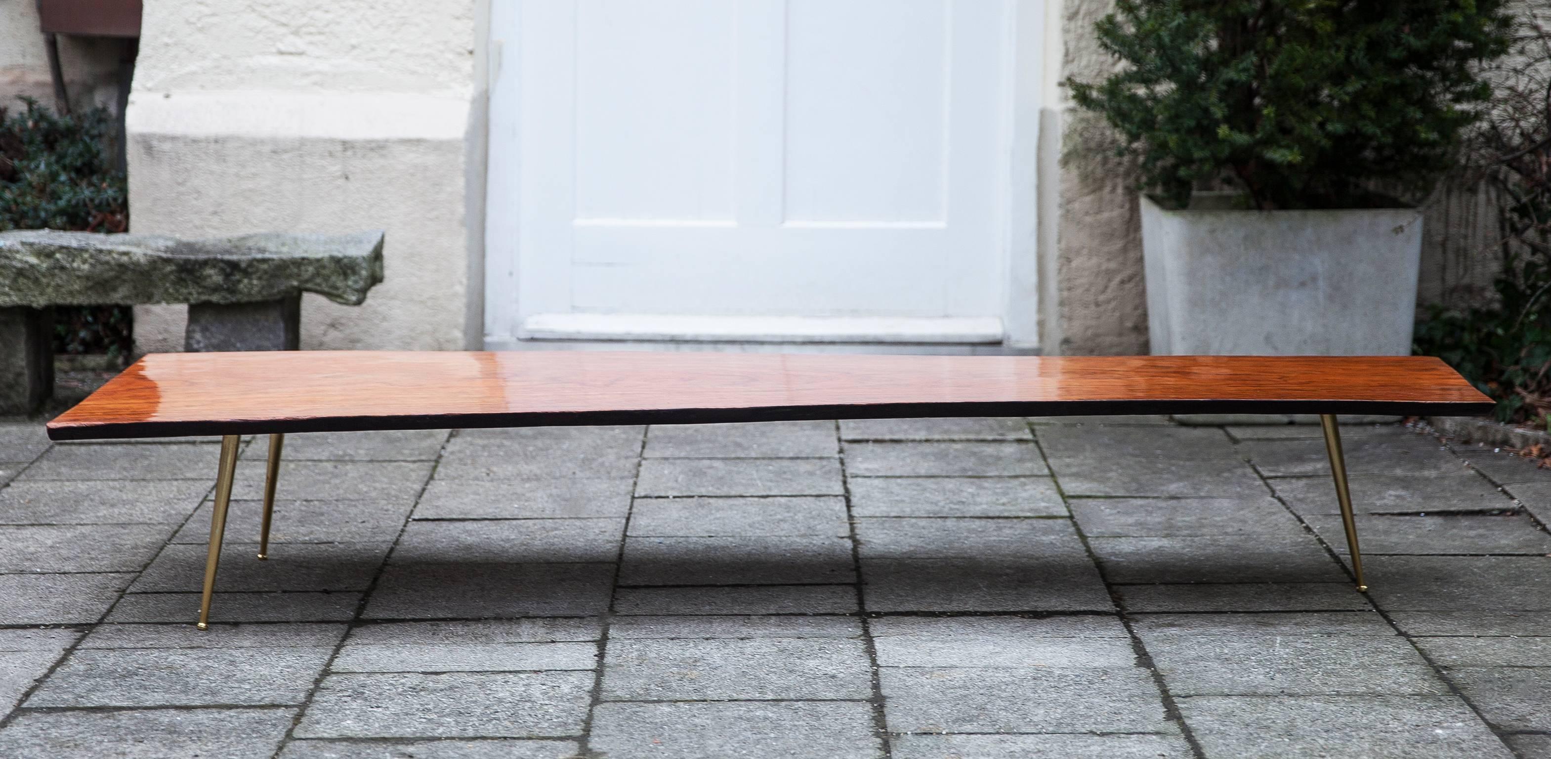 Very elegant tripod tree trunk table, with brass feet and a fantastic teak structure, France, 1960.
Measures: H 31, B 193, D 63 cm.