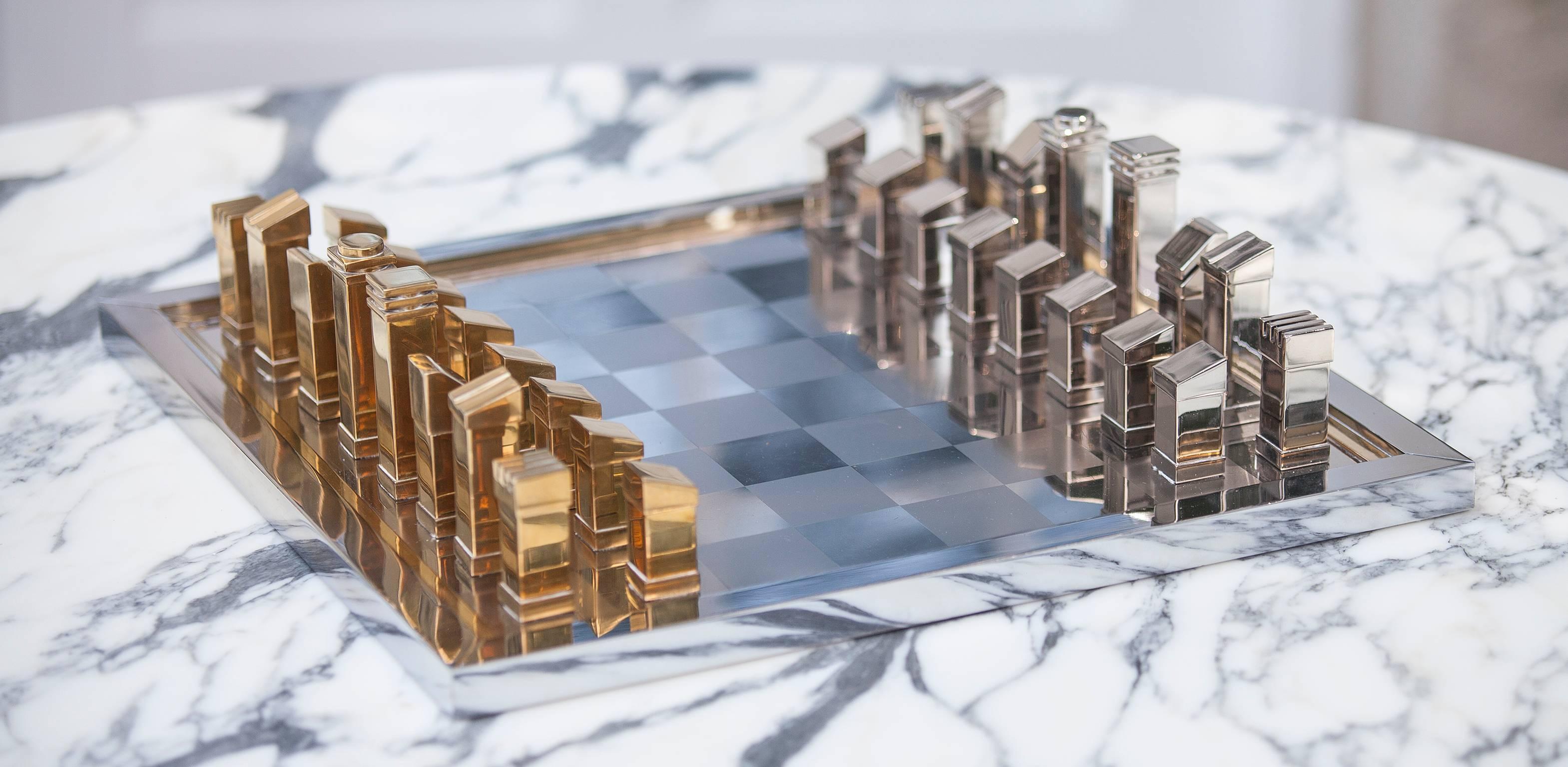 Stunning Bicolor chess set by Romeo Rega on a stainless steel board.
32 playing pieces high quality manufactured in brass and polished nickel. Signed 