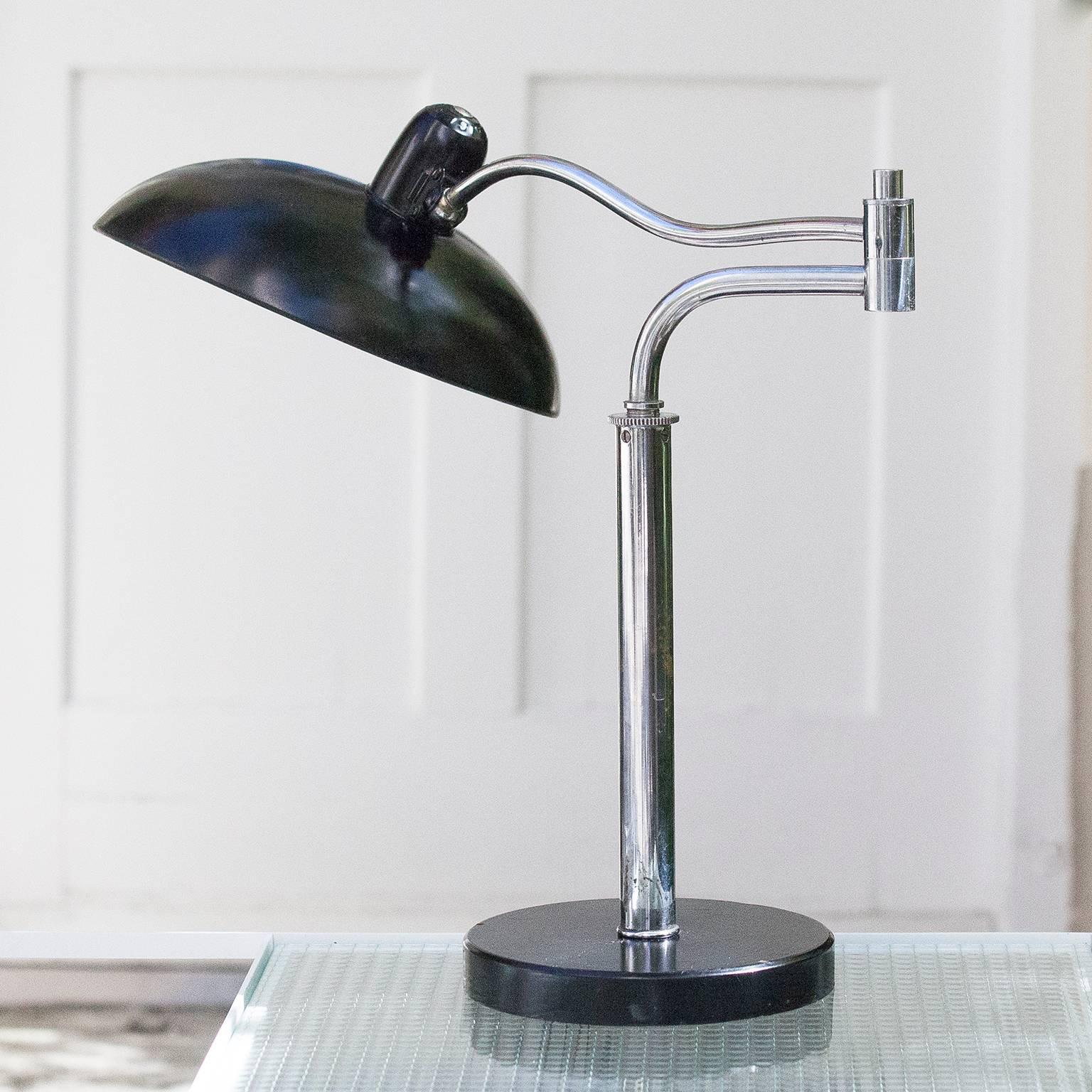 Very rare Bauhaus table lamp mod. 6651 by Christian Dell for Kaiser and Co., Neheim-Hüsten, Germany.
Design and execution of the 1930s.
Black lacquered and chromed metal, bakelite switch.
Height-adjustable, rotatable and can be swivelled through