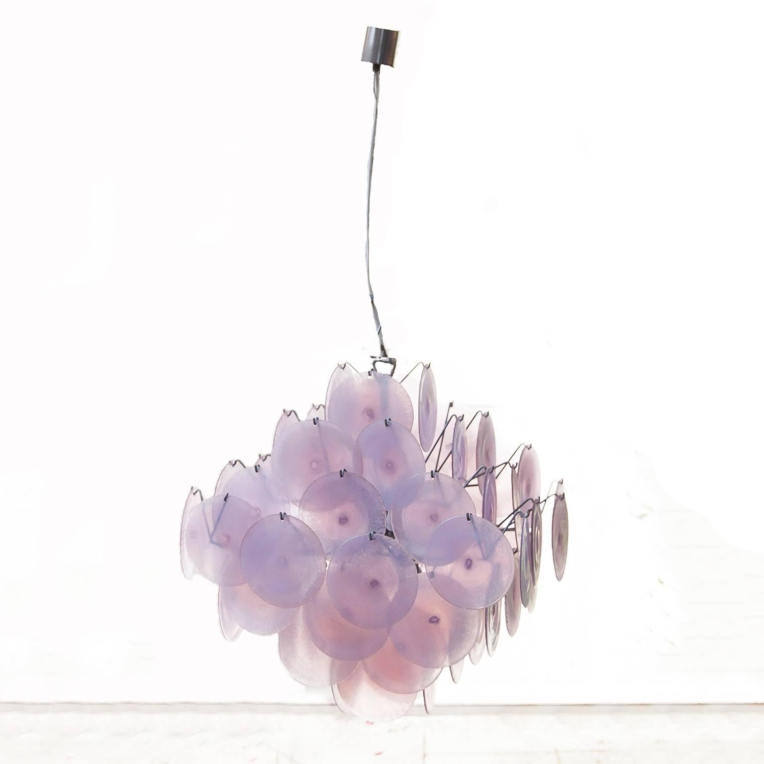 Huge original Murano glass chandelier by Carlo Nason for Mazzega.
The chandelier is compost of 64 Murano opaline glass discs which color is like a rainbow while illuminating
Measure: H 65 (110 with cable) x B 60 cm.