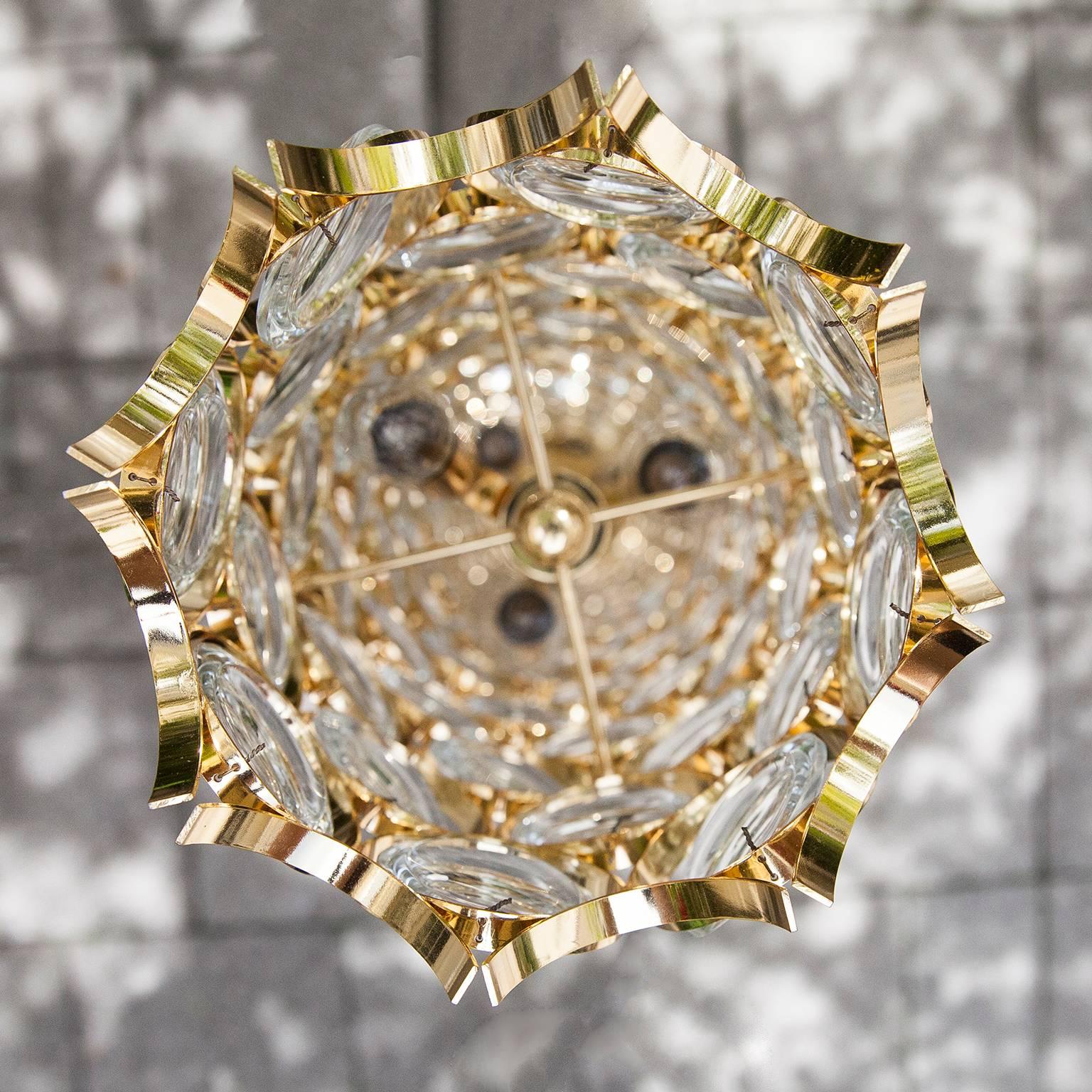 Gorgeous Hollywood Regency style floor lamp in gilt brass and with 160 glass crystals made by Palwa, Austria, 1960s. 
This Hollywood Regency crystal glass disc column floor lamp, has a frame of real gilt metal. It needs nine x E14 standard screw