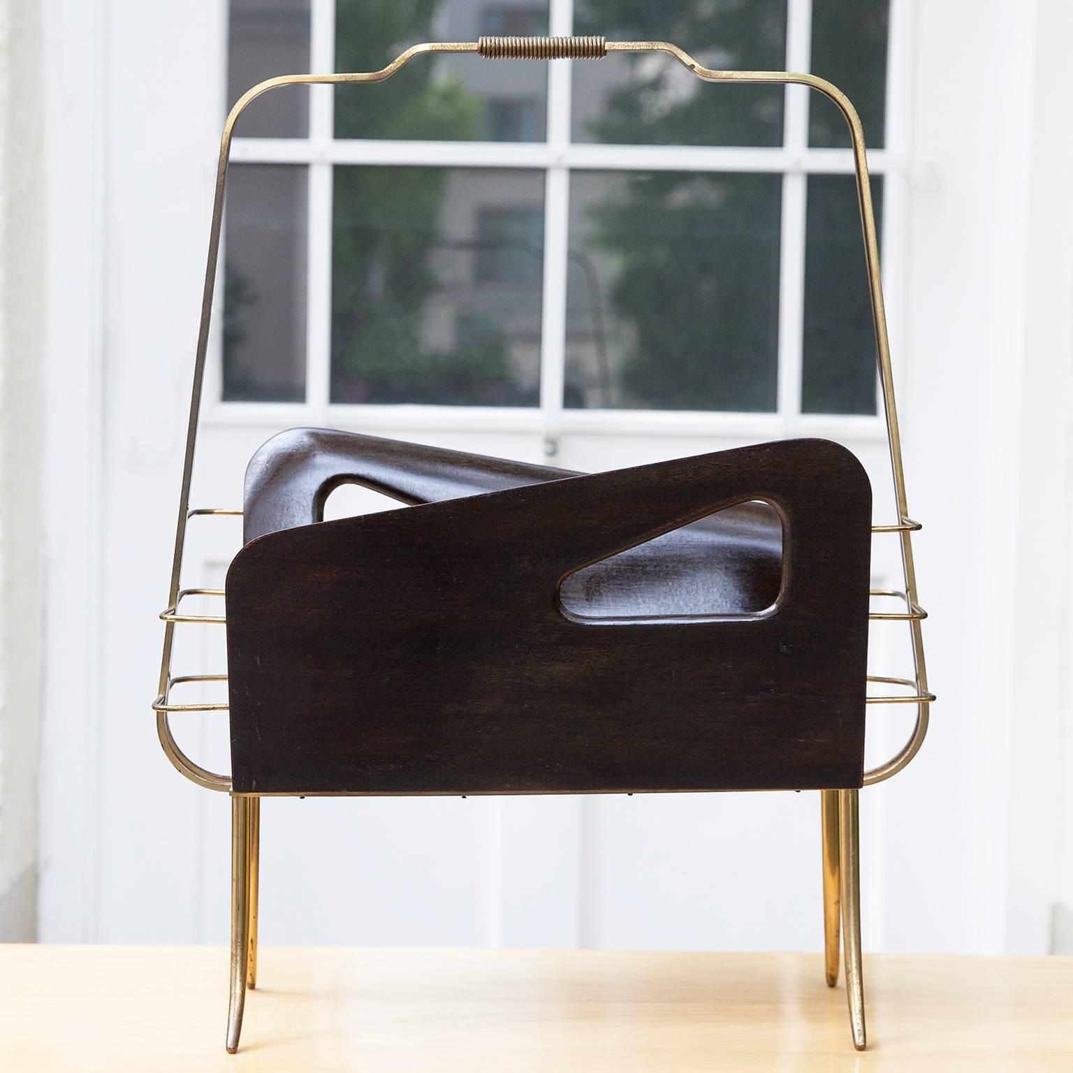 Gorgeous 1950s Italian magazine stand made of brass and walnut with geometric cutouts and sharply planed edges.
The maker is making an obvious salute to the organized wall creations of Gio Ponti in the 1950s.
H 61 W 47 D 20 cm.
   