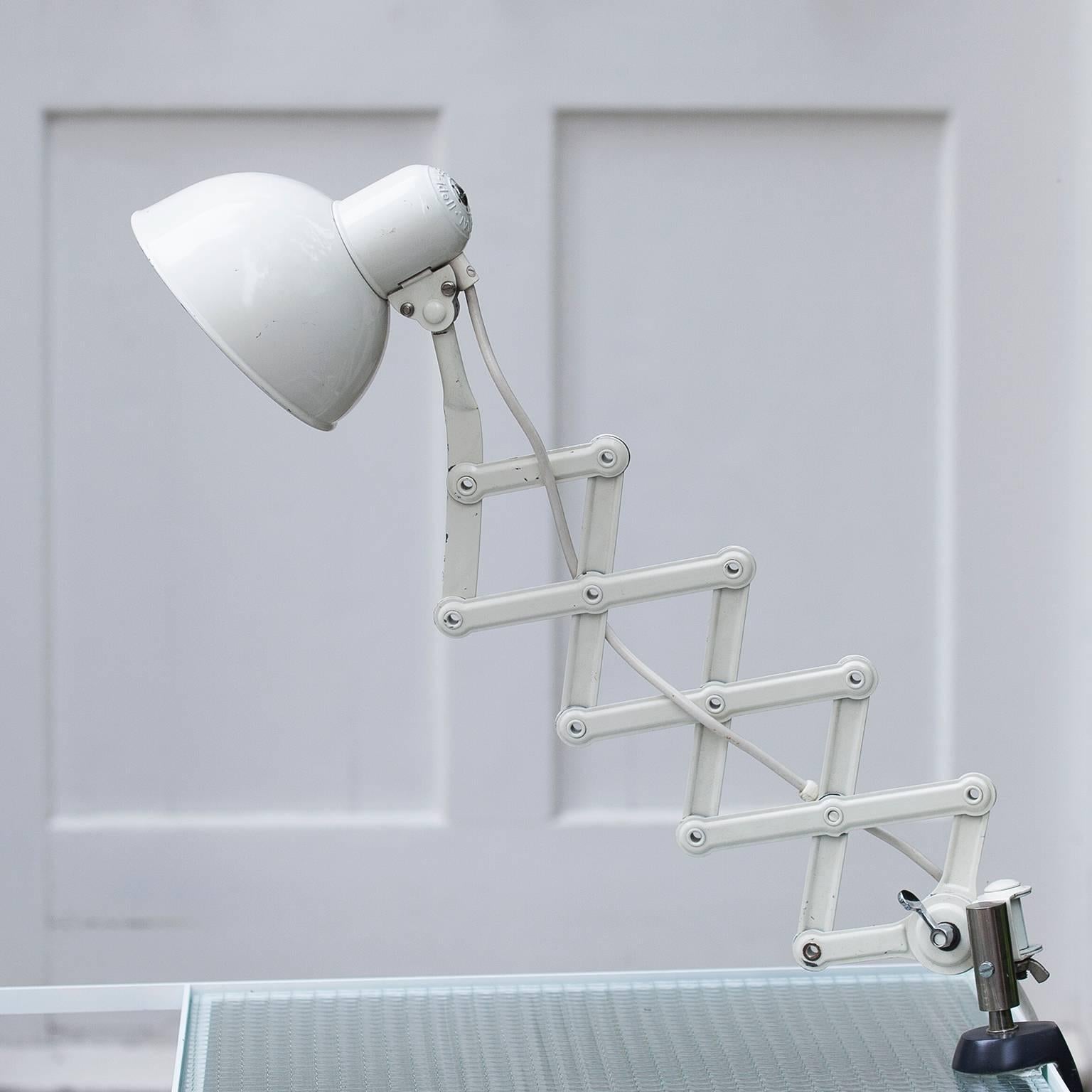 Rare desk mounted Christina Dell Bauhaus table lamp for Kaiser Idell, swing arm lamp of white painted metal with Gate-Fold Mechanism. Signed on shade and the base. Largest width around 80cm. Ten are available.
