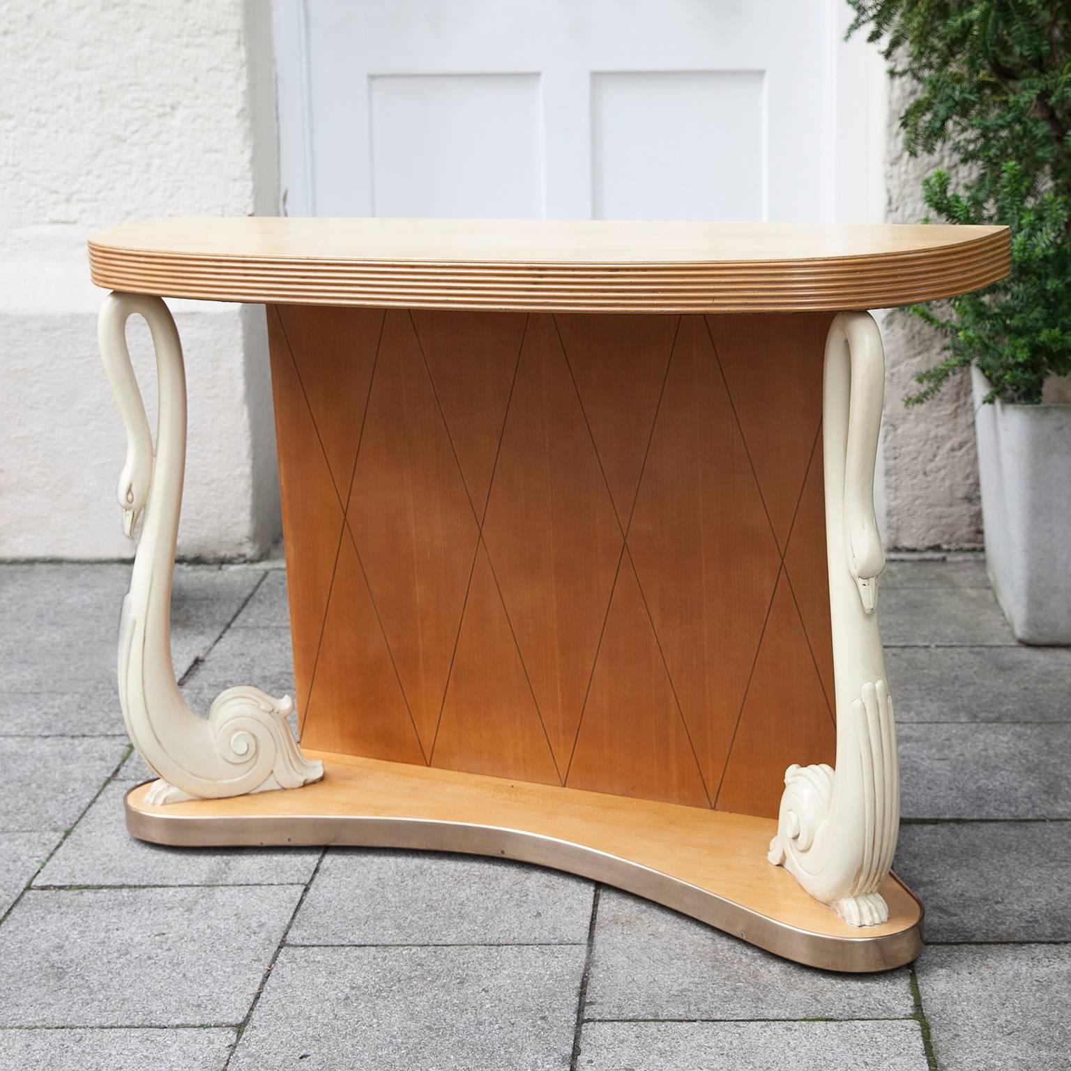 Italian console table, attributed to Osvaldo Borsani. Typical S-shaped swan legs on a semi-circular birchwood stand and top.

Measures: H 82, W 116, D 34.7 cm.