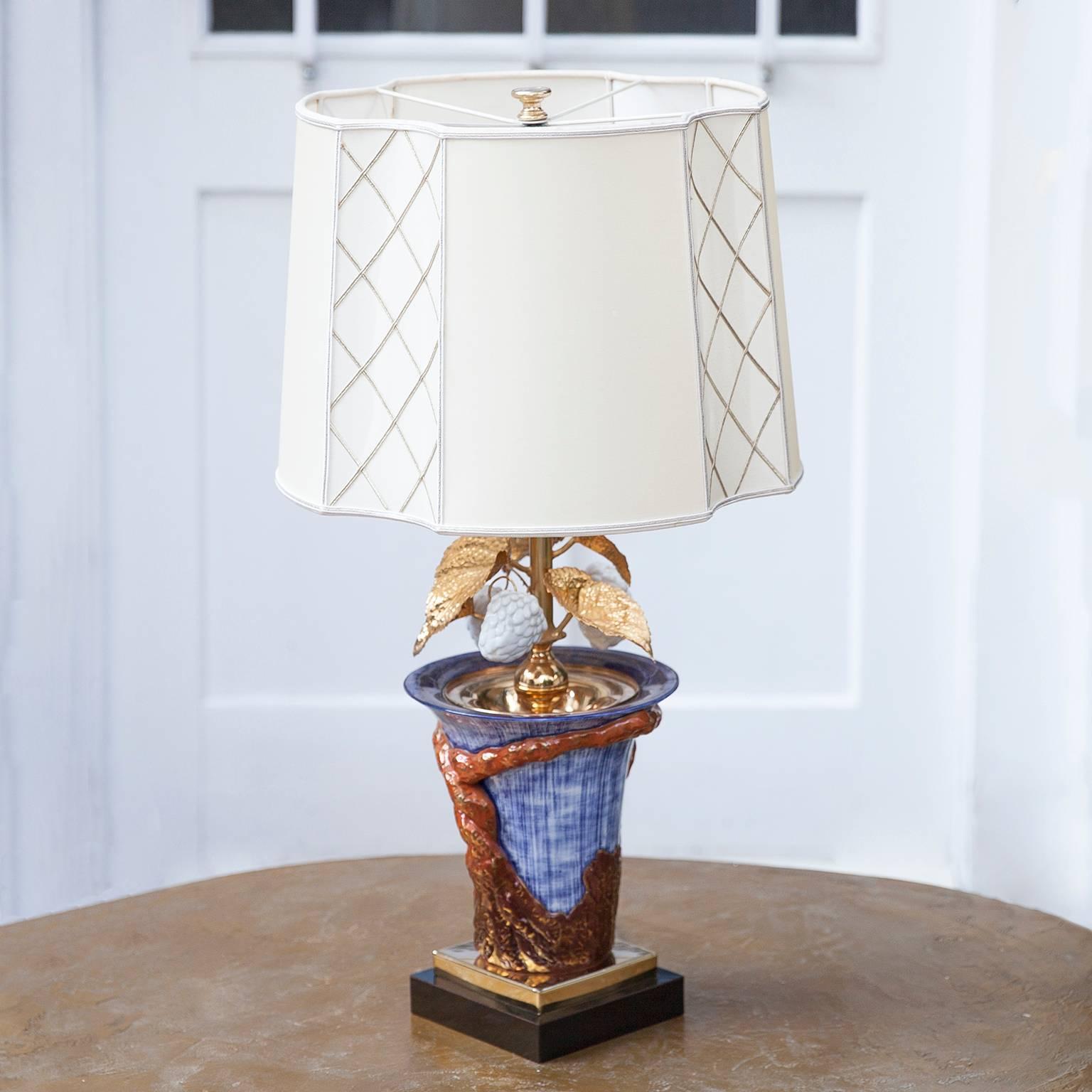 Very elegant French porcelain table lamp with silk shade and gold plated leaves and white porcelain fruits, France 1970s.

Measures: H 73 x D 35 cm.