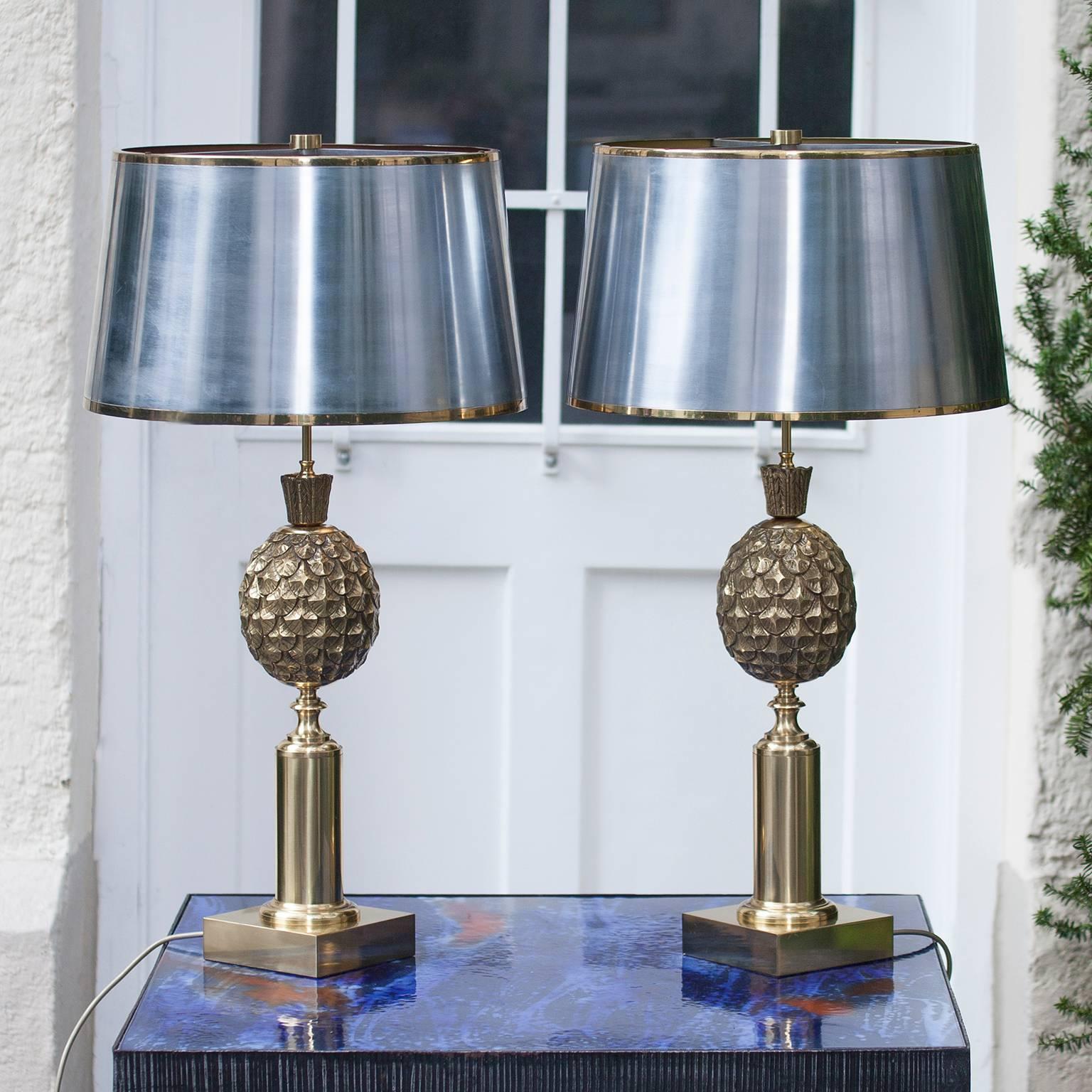 A set of two gilt and bronze table lamps attributed to Maison Charles with a metal shade, featuring a beautifully executed pineapple motif.
France, circa 1960.
    