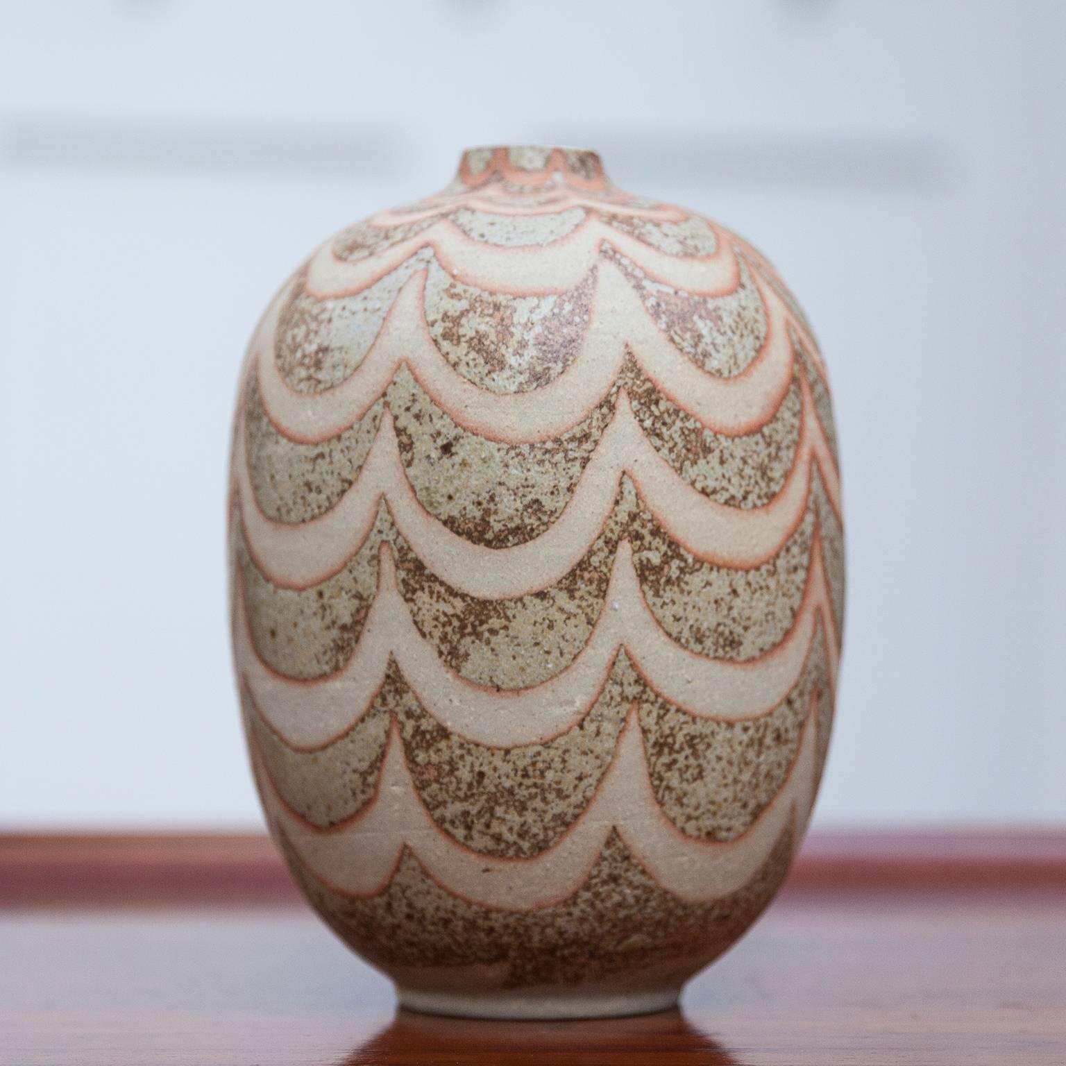 Fantastic unique stoneware Uzumaki vase, partially unglazed using a wax-resist
method, with matte brown and beige red glaze, 1991.
