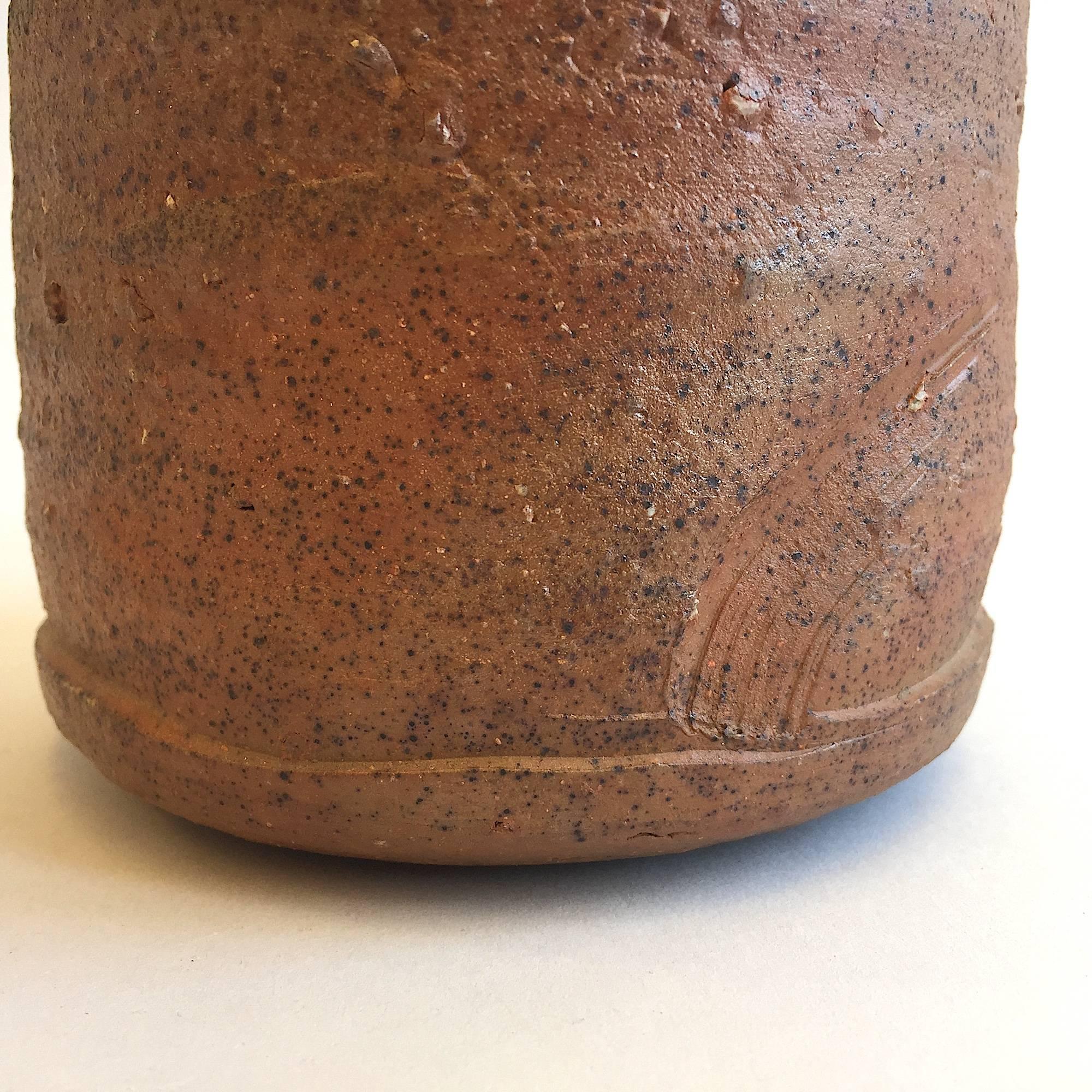 Horst Kerstan
(1941-2005 Kandern, Germany)

Unique minimalist art pottery wood-fired ceramic vase. Made in the first Japanese anagama wood oven in Germany after his trip to Japan. Red clay. Partial incised decor. Fire glaze.

Measures: H 14.5 x