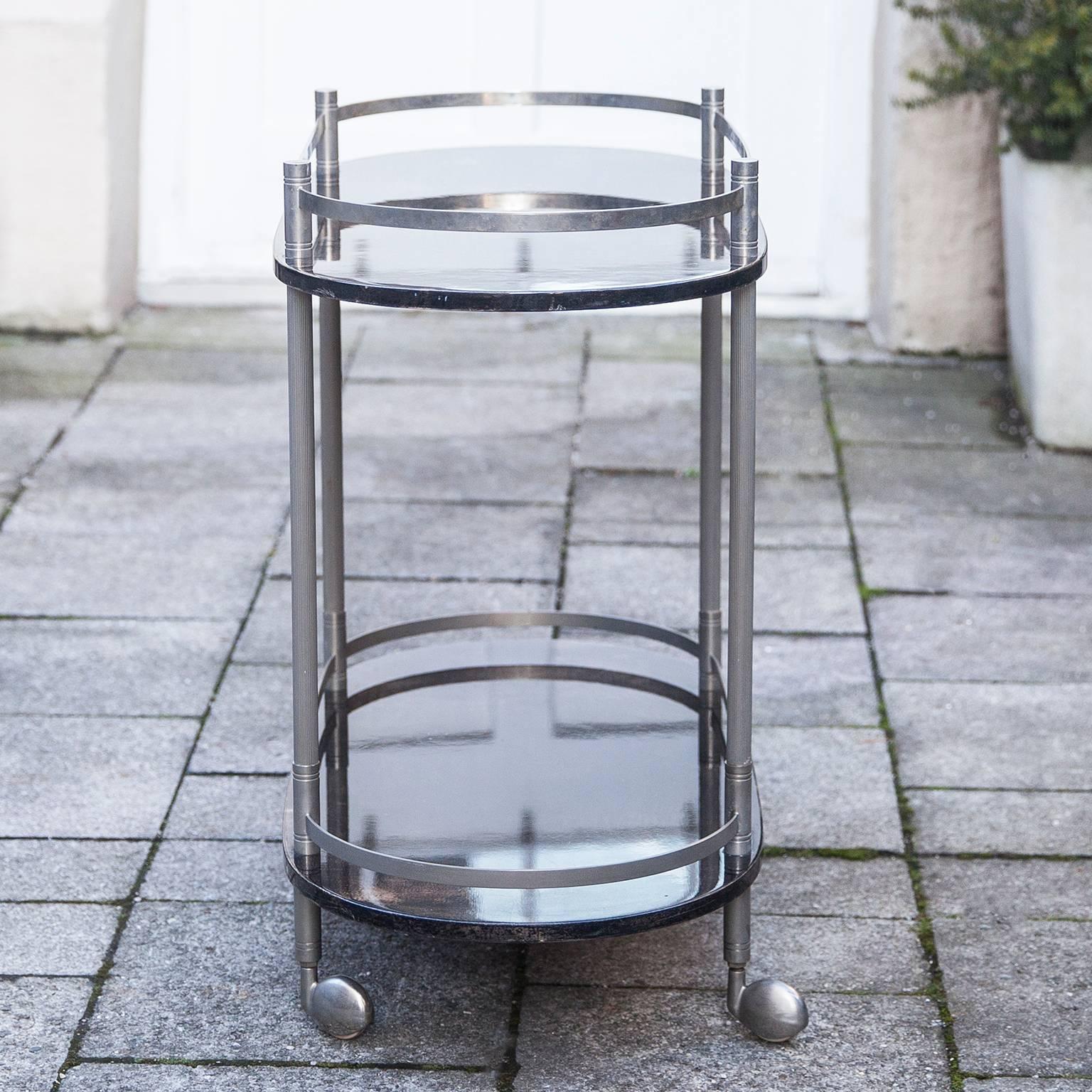 Fine bar or serving cart by Aldo Tura Milan, Italy, 1960s. The bar cart is made
of anthracite brown lacquered goatskin and nickel-plated elements.
Measures: 40.2 D x 89 B x 72 H cm.