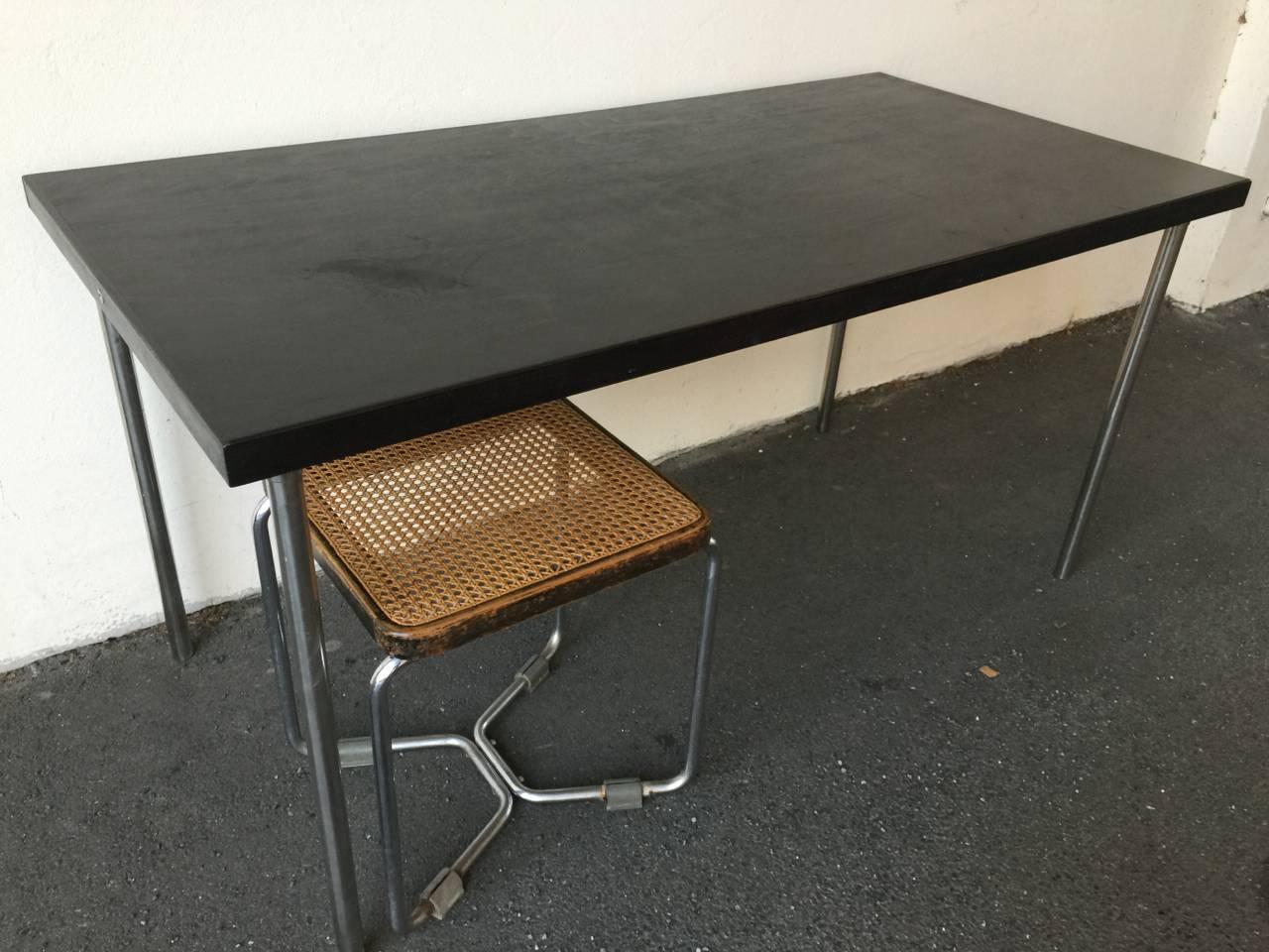 ebonized wood chromed metal. marked and in good vintage condition. matching stool also available.