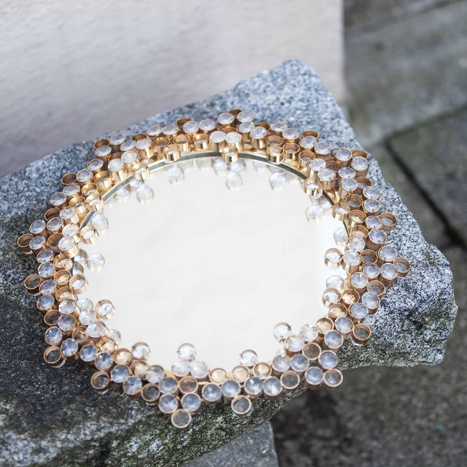 Round mirror surrounded in crystals and gold, Austria, 1965. Gold plate, Swarovski crystals, clear mirror.