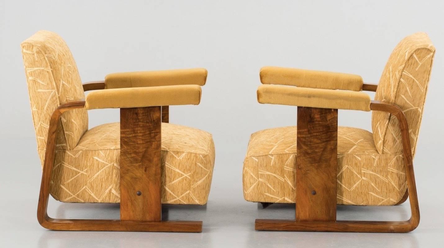 By unknown designer and manufacturer. Reupholstered a while ago in wonderful bamboo style fabric. Armrests in velvet. Walnut base.