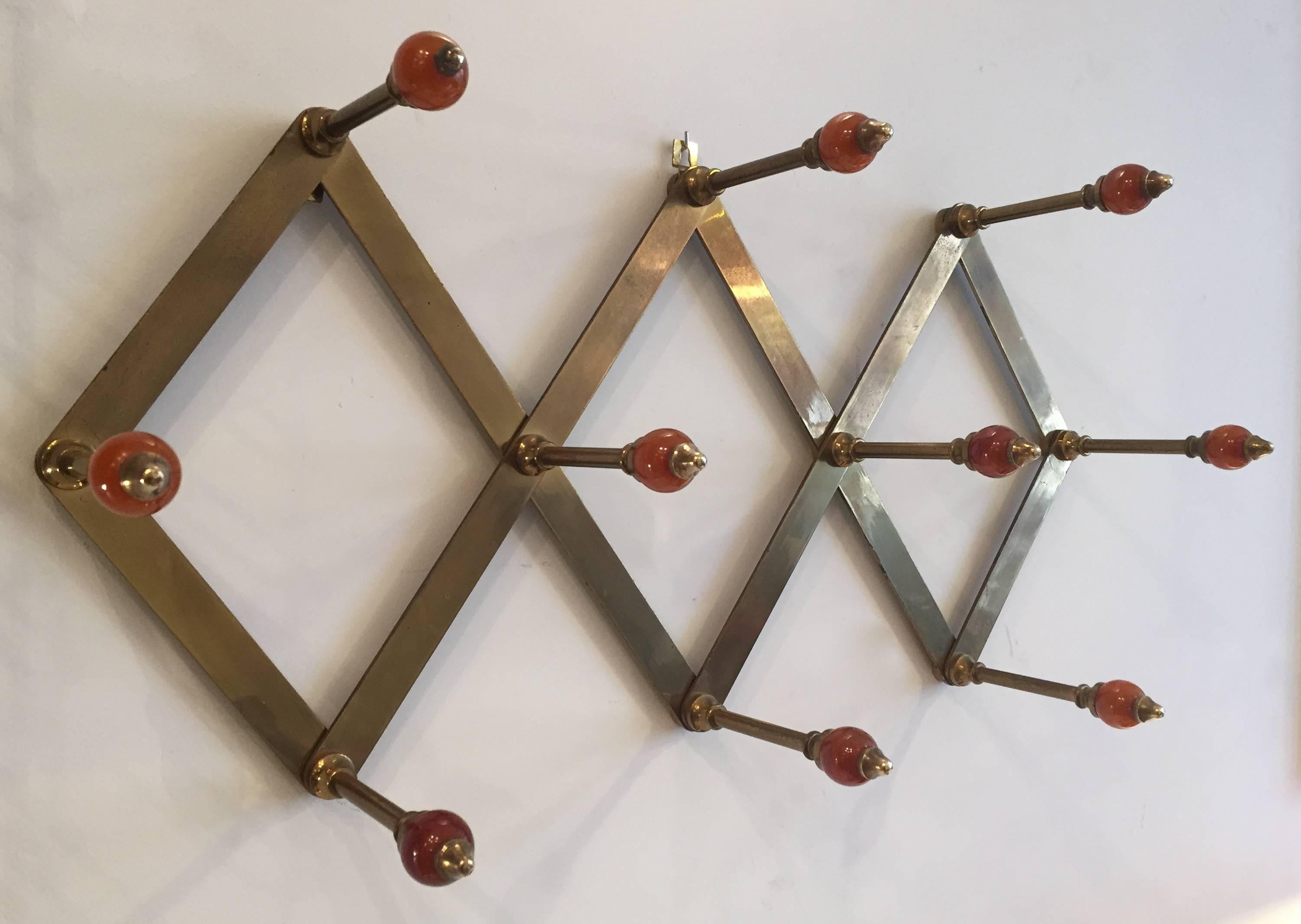 An expandable coat rack designed by Luigi Caccia Dominioni for Azucena in the 1950s. Stamped. Brass frame and ten red resin balls. Superb condition.