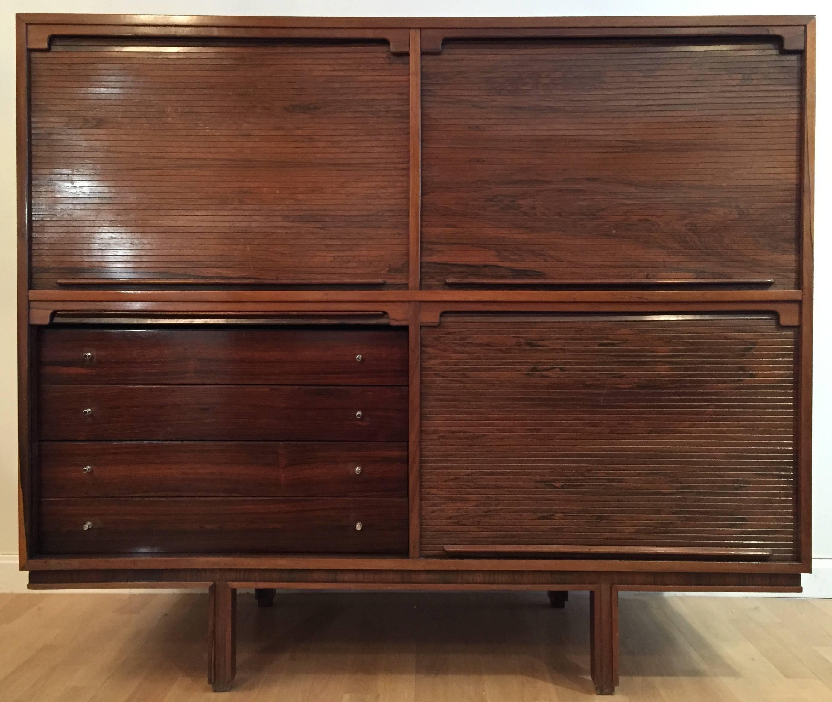 A rosewood Mid-Century cabinet designed by Gianfranco Frattini and edited by Bernini in 1957. Four sliding tambour doors, inside with shelves of adjustable height and four drawers. Excellent original condition.
